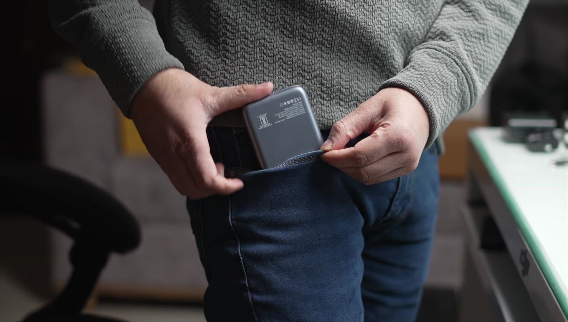 The power bank attached to a smartphone, demonstrating ease of handling.