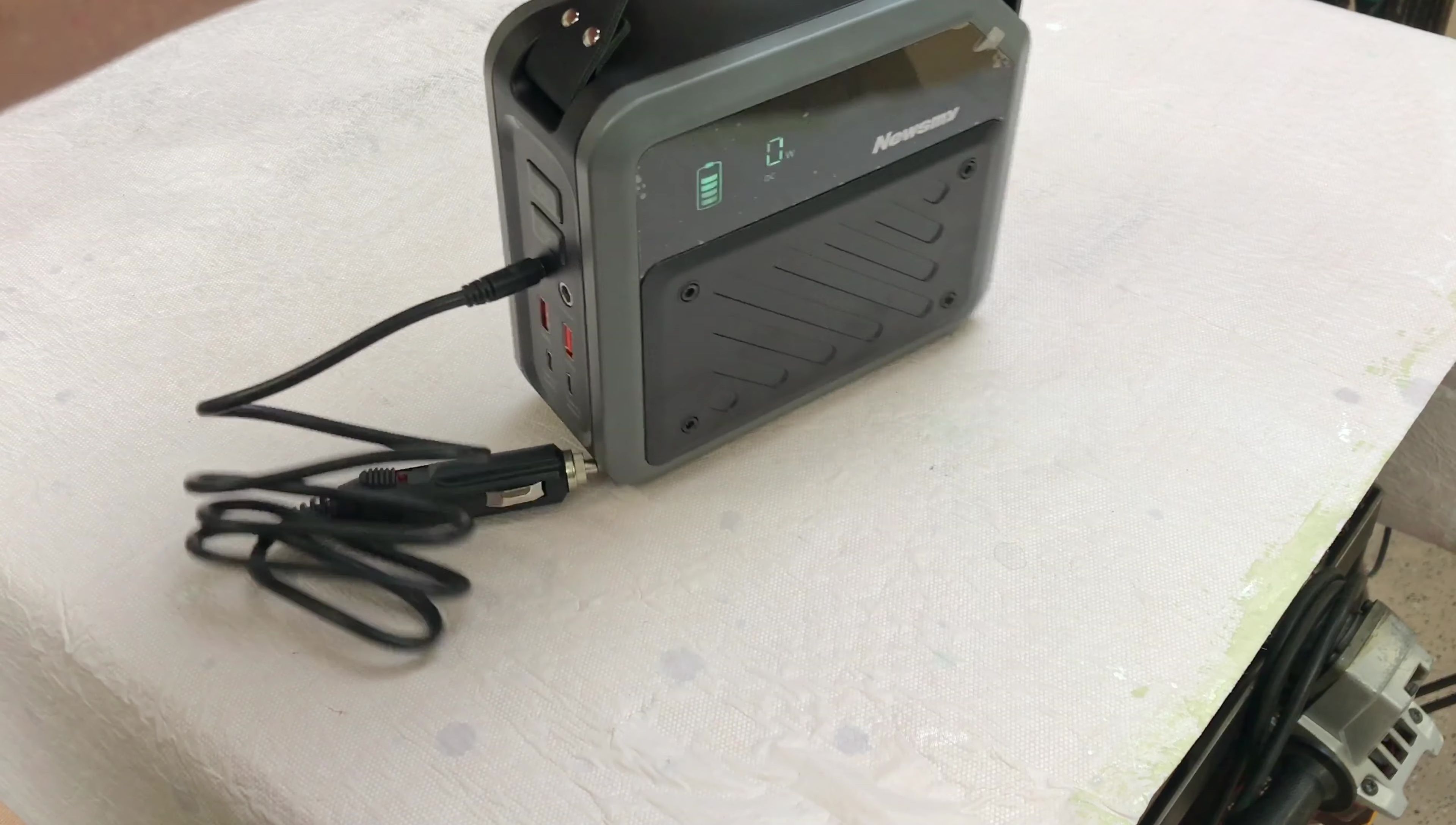 Car adapter plugged into power station