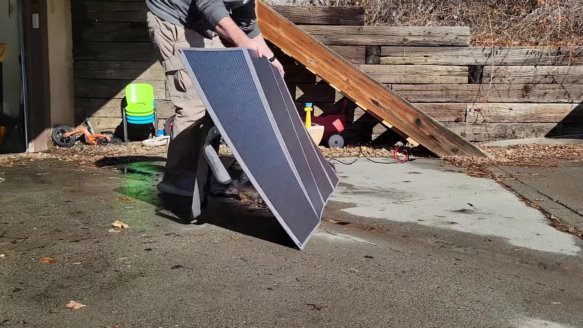 The reviewer demonstrating the ease of setting up the solar panel.