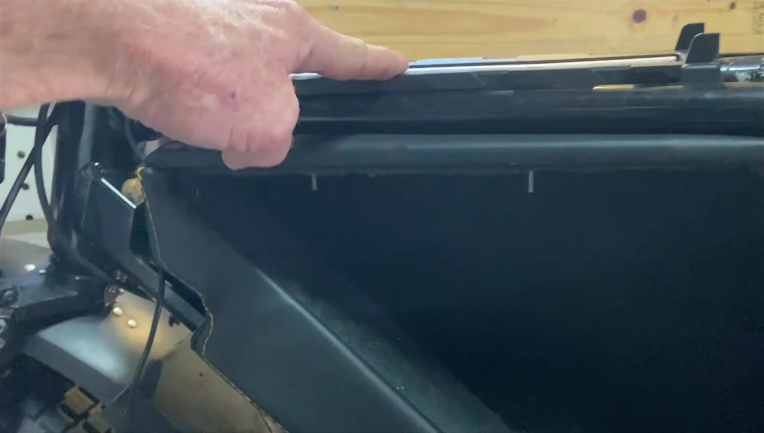 Close-up view of the battery box secured to the ebike frame, showing the bolts and steel tabs.