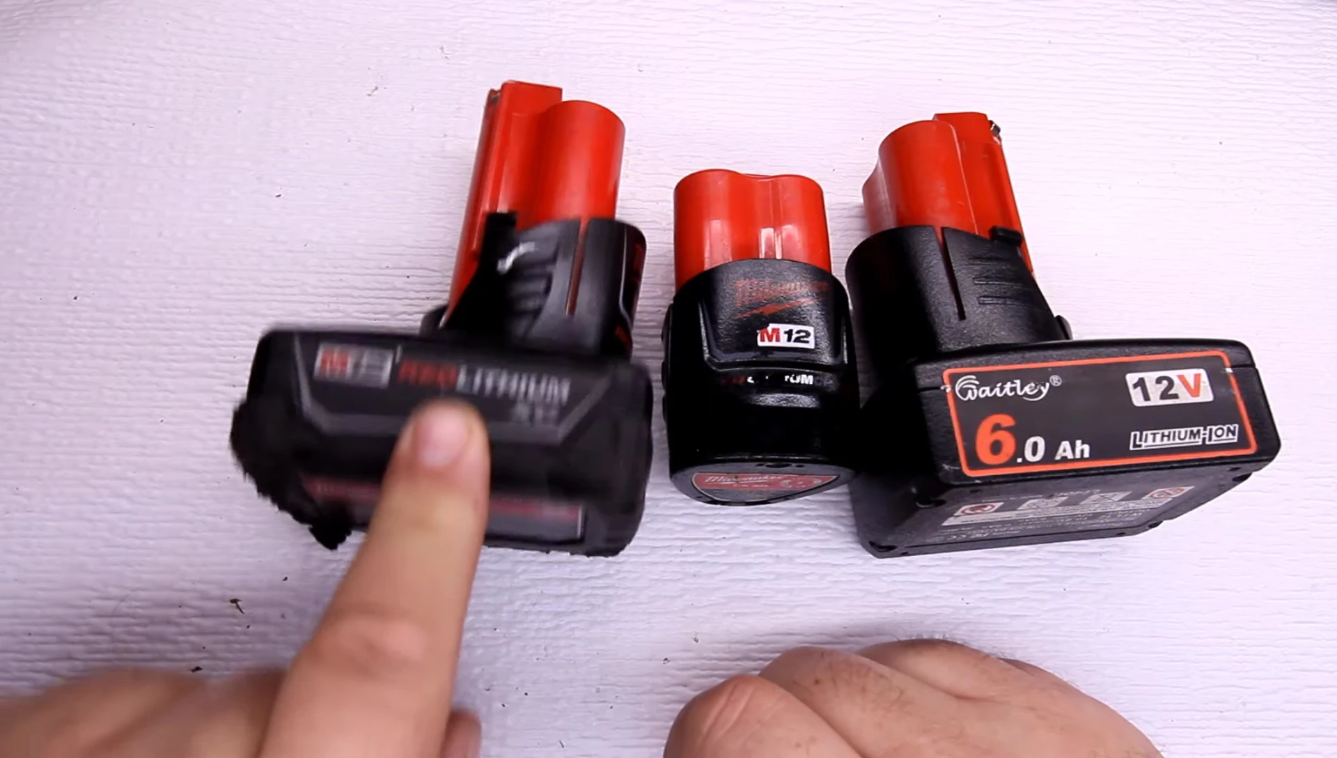 Close up of the Milwaukee 3.0Ah battery with price tag overlayed
