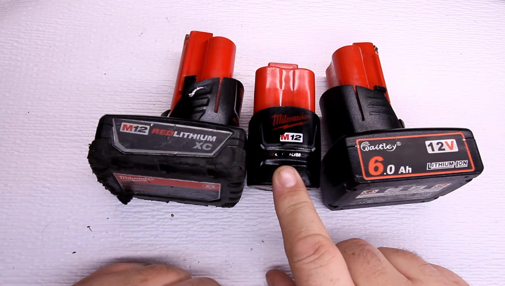 Close up of the off-brand 6.0Ah battery with price tag overlayed