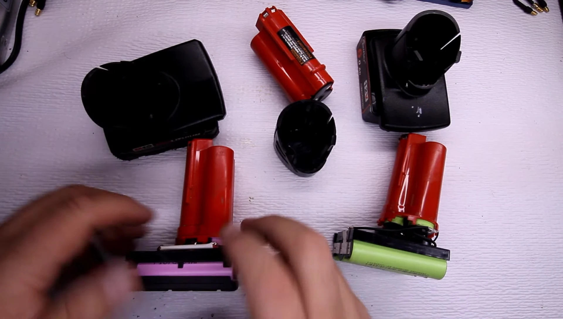 Disassembled Milwaukee battery, showing internal components and cell type