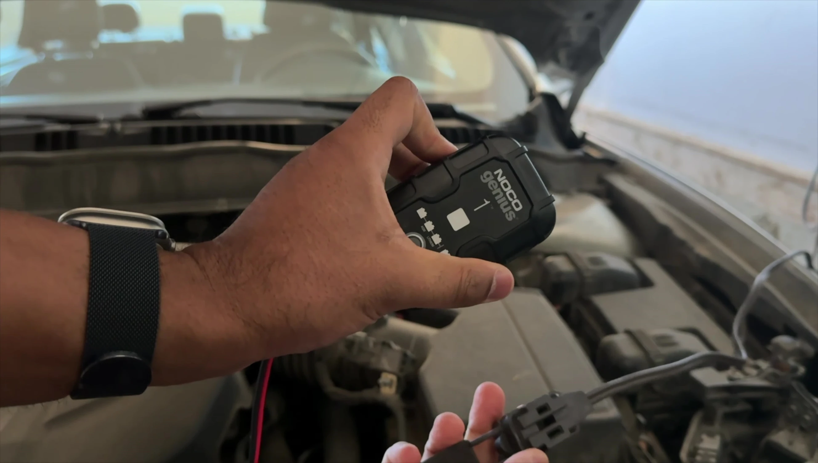 Connecting the charger to the power outlet.
