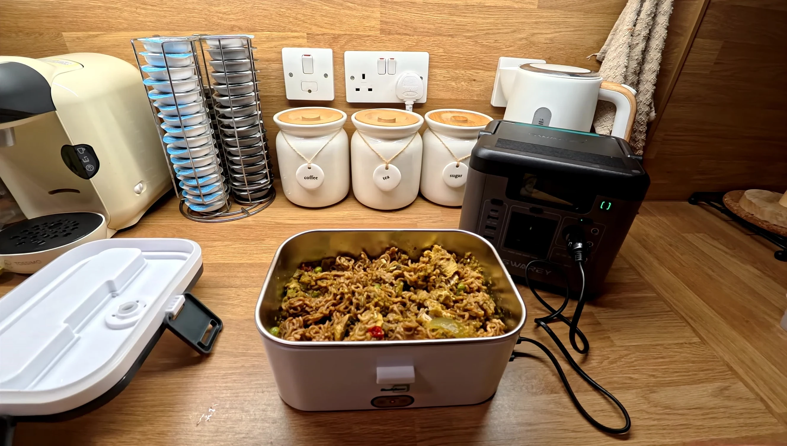 Opening the lunchbox to check the food temperature and stir.