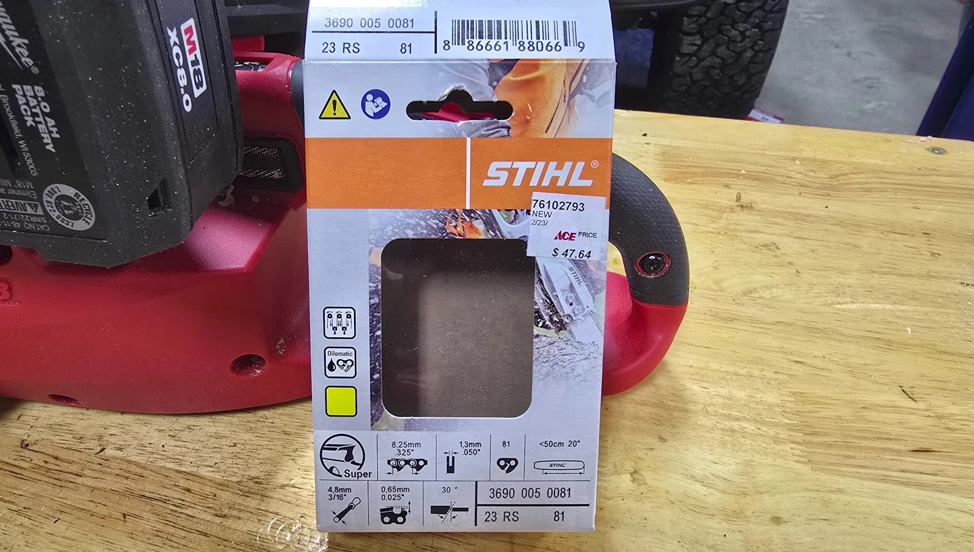 Close up shot of the upgraded steel chain on the chainsaw.