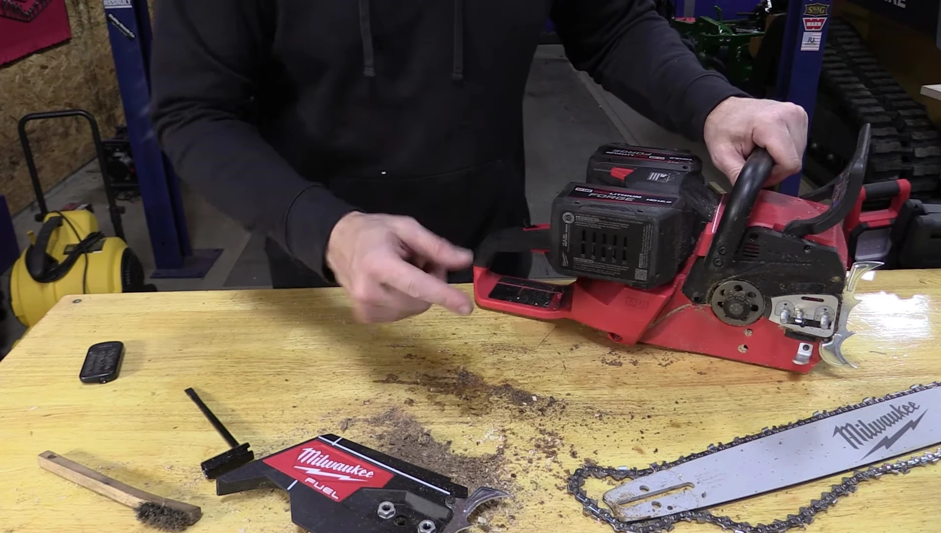The reviewer pointing out the water in the chainsaw.
