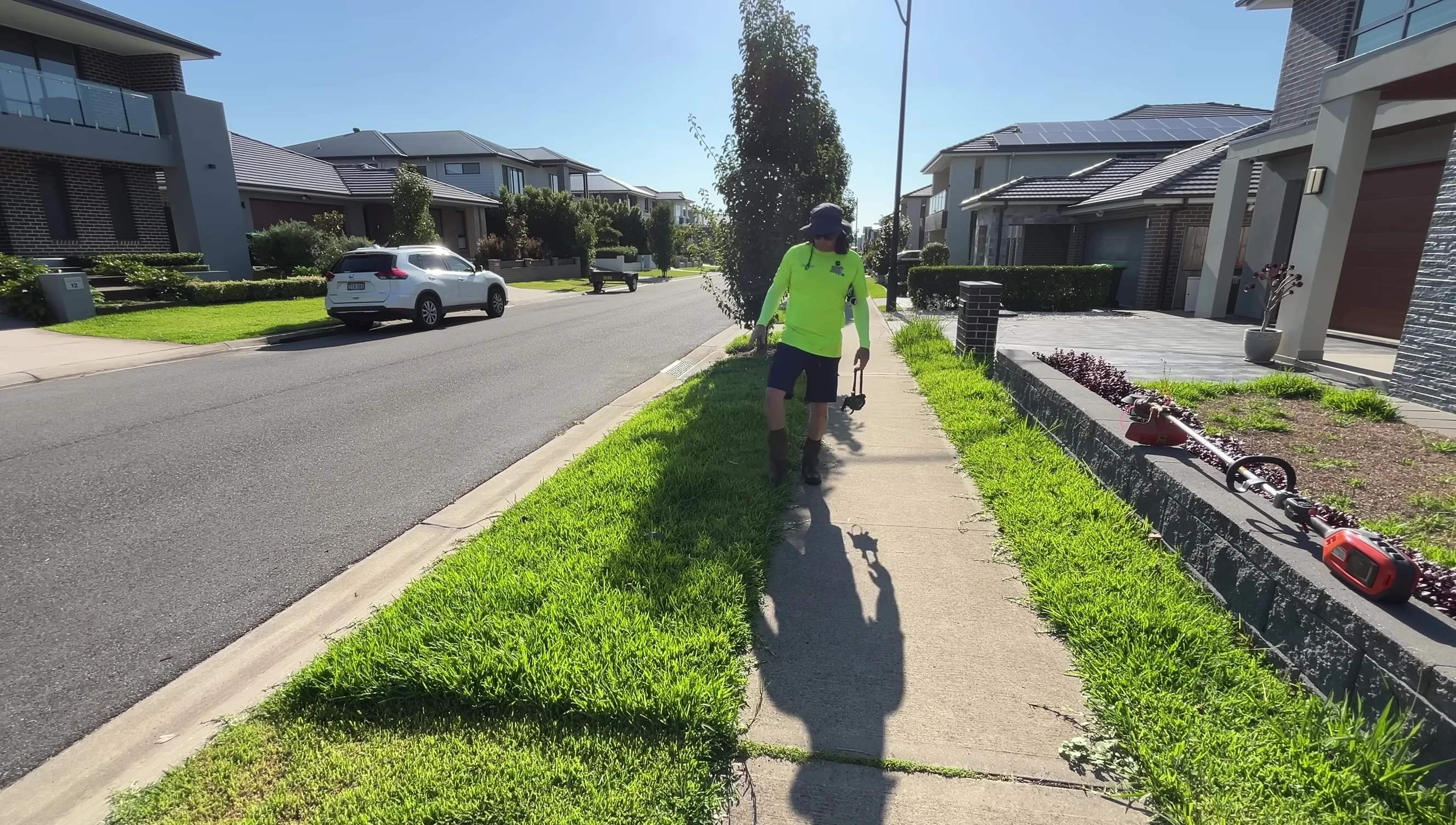 The trimmer being used on a neatly mown lawn.