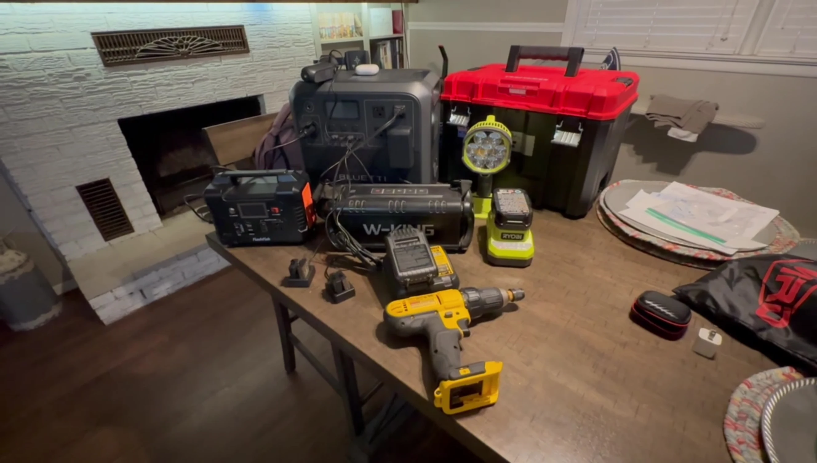 Multiple devices plugged into the Bluetti AC180 for charging