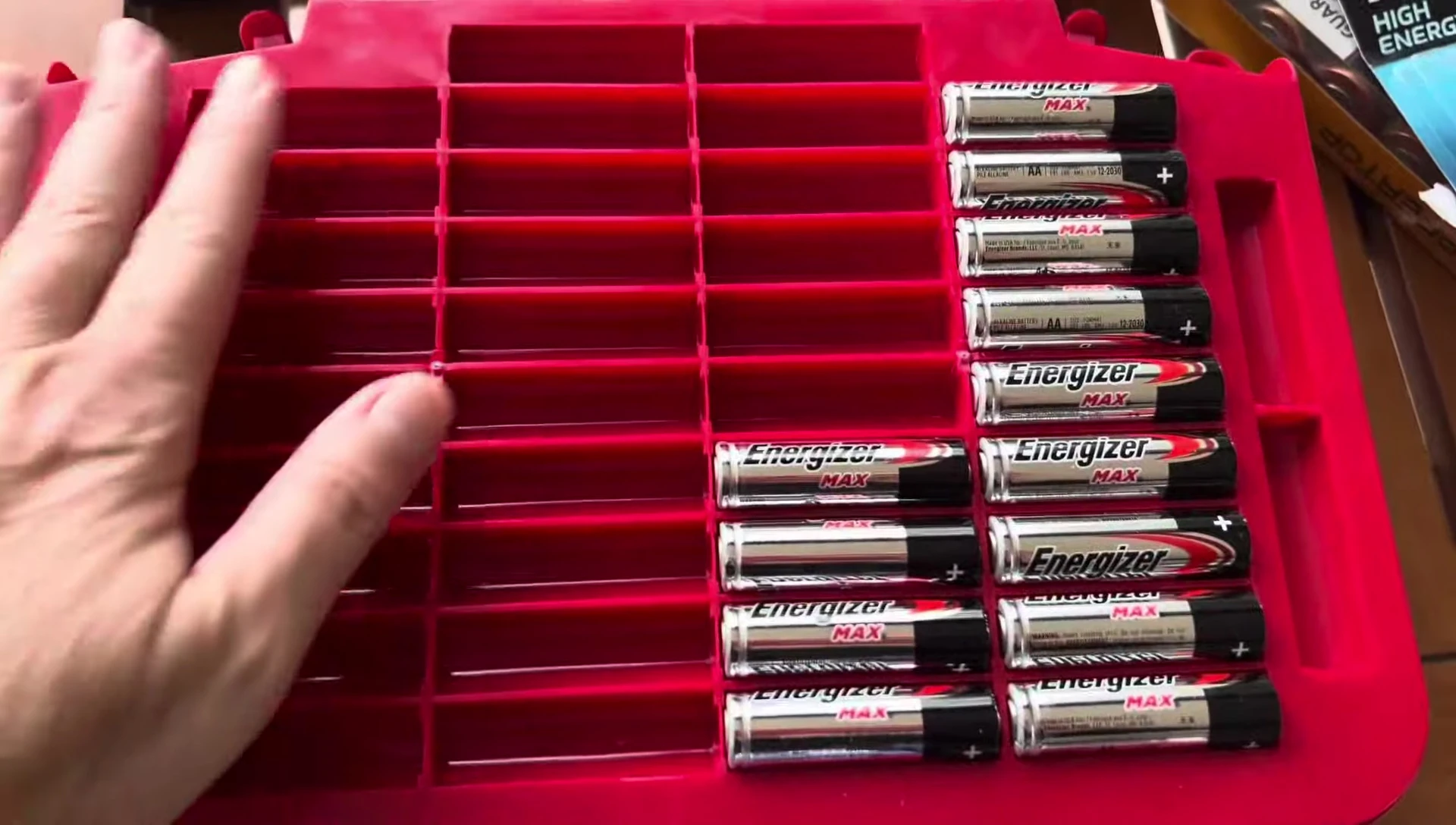 The Battery Daddy open, showing neatly organized AA batteries.