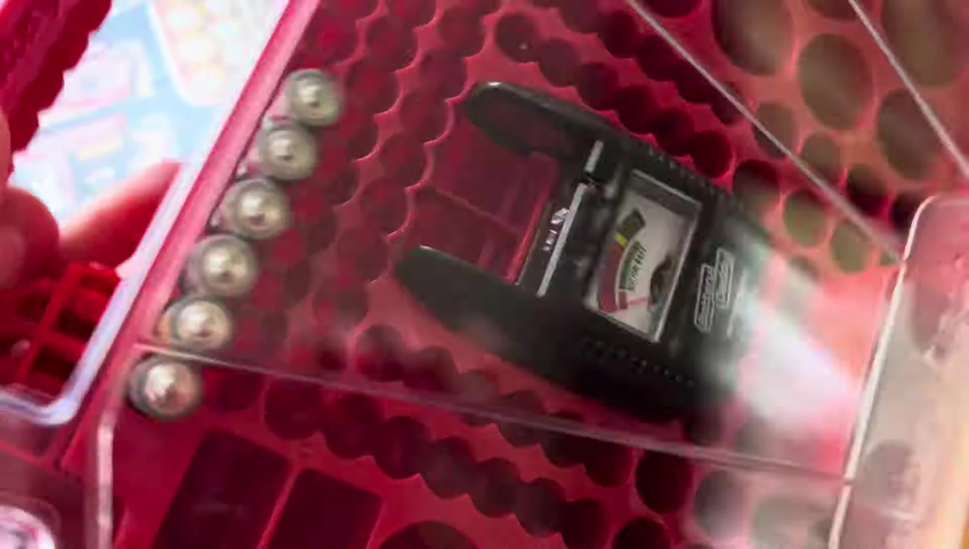 The Battery Daddy shown upright with various battery types inside.