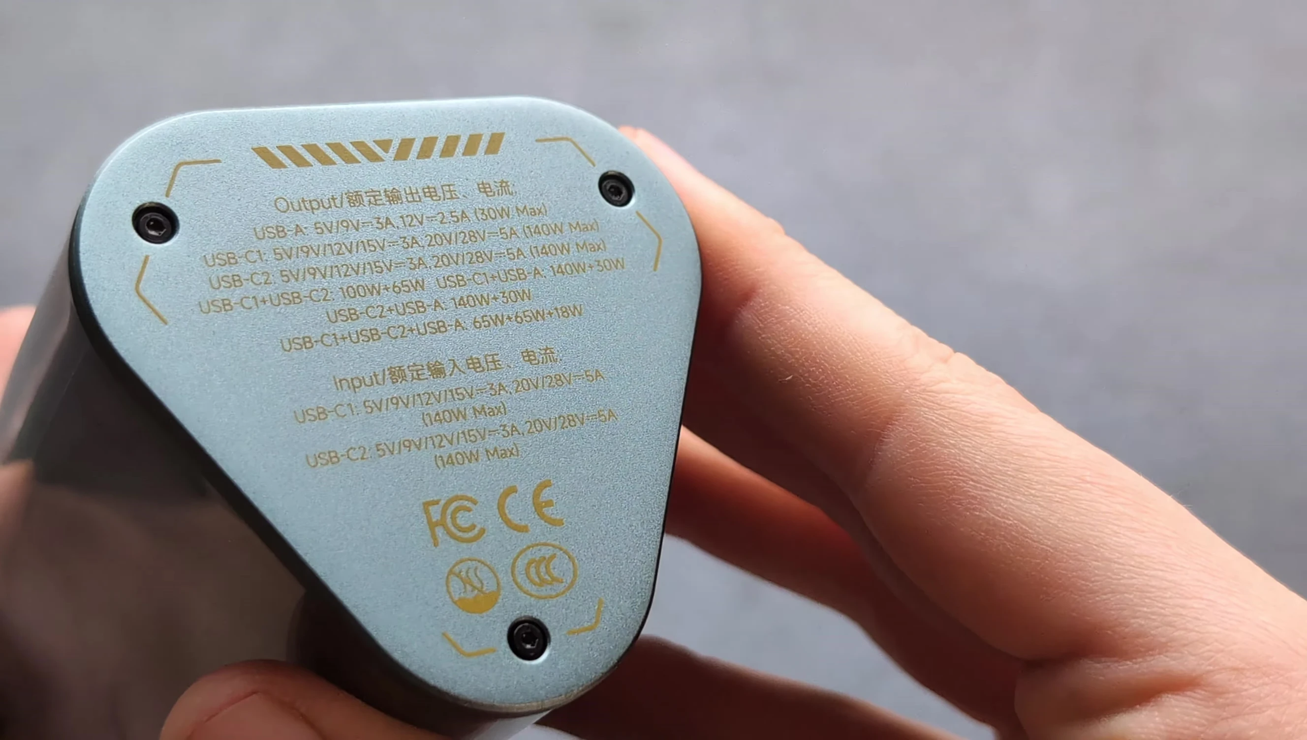 Close-up of the power bank showing output and input power details
