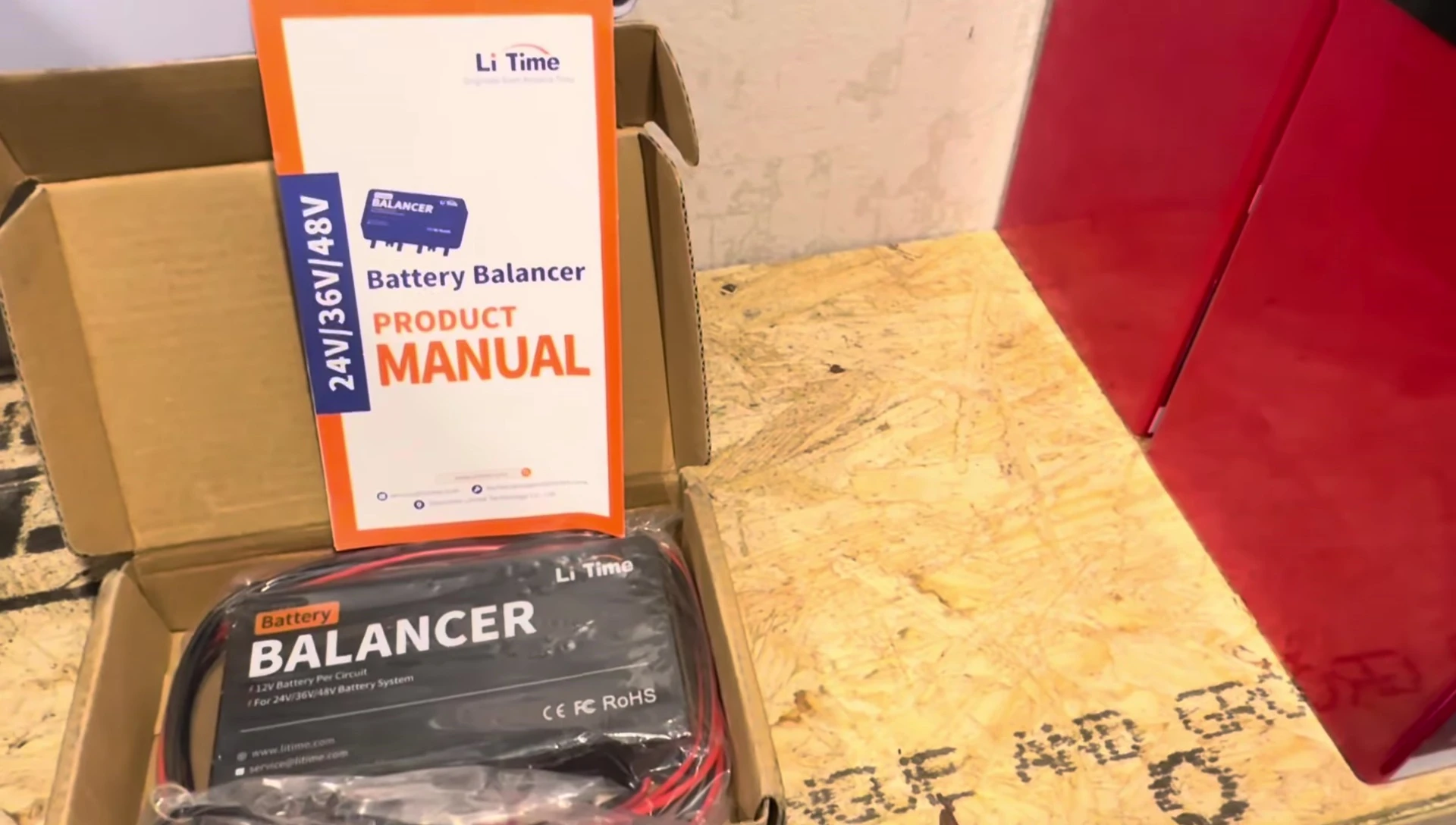The LiTime battery balancer shown on the workbench