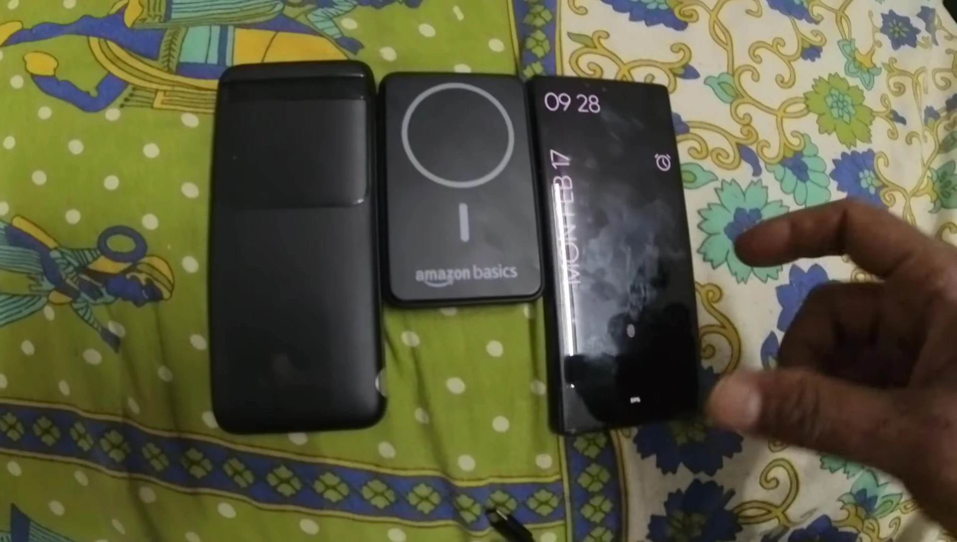 Size comparison of the power bank with a Pixel 6 Pro and another power bank.