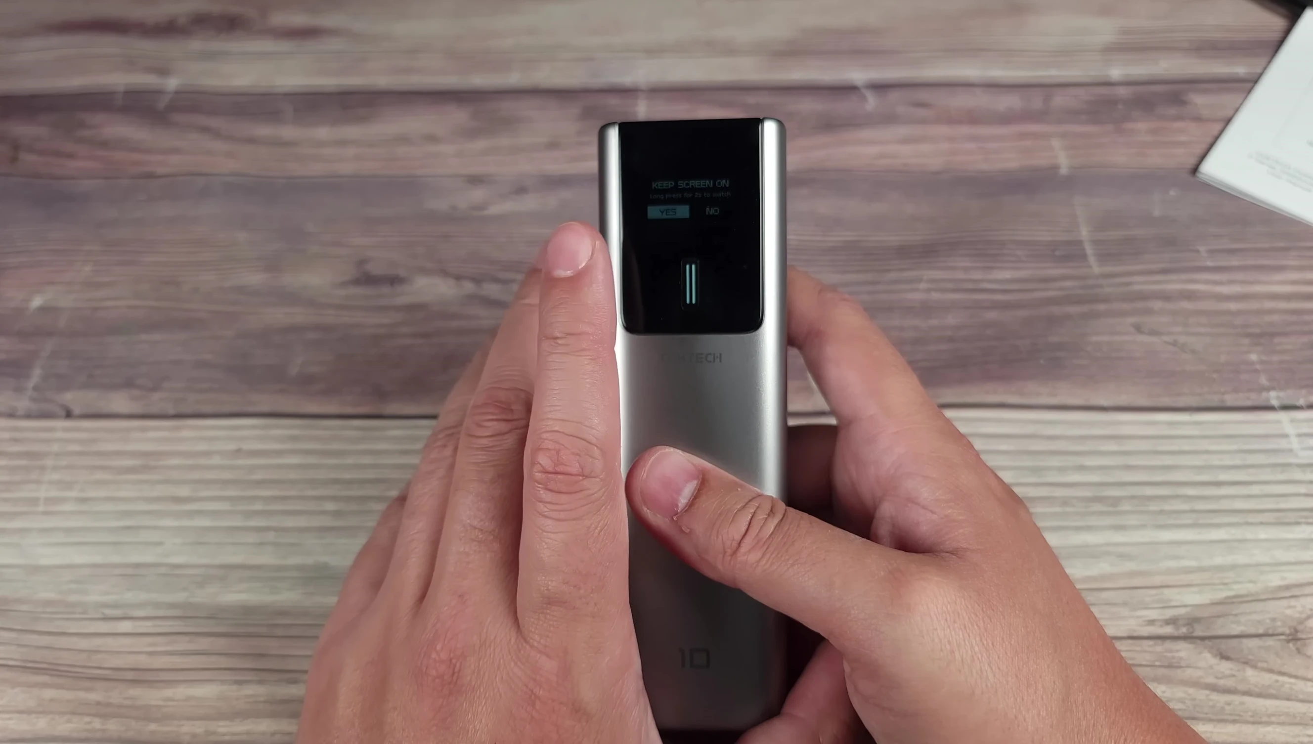 The CUKTECH 10 showcasing its low-current mode selection button.