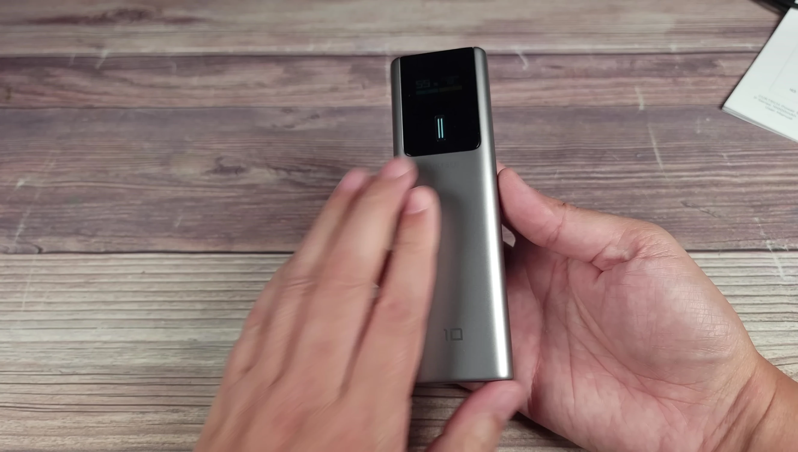 Close-up of the CUKTECH 10 power bank showcasing its silver color and textured back.