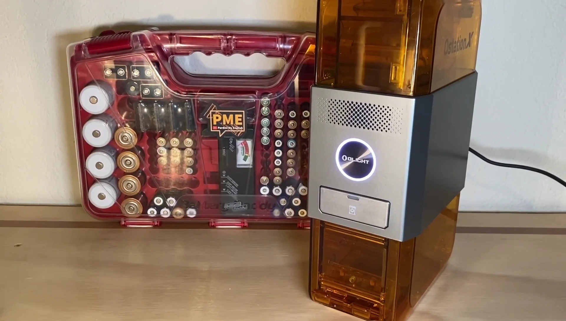 The Olight OStation X after processing the batteries, showing the remaining batteries and the rejected batteries in the tray.