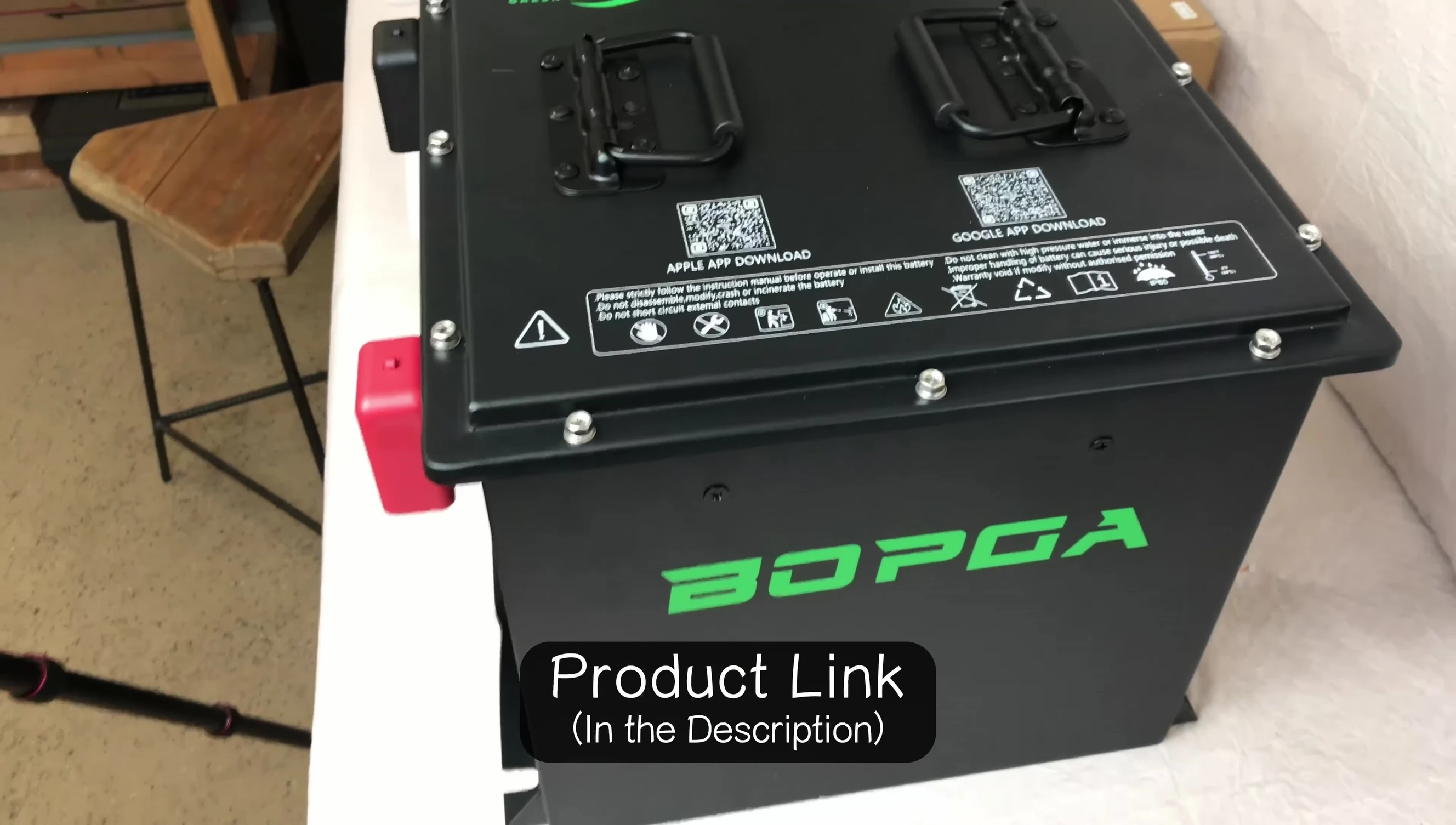 Close-up of the BOPGA MINI battery showing its compact size and carrying handles.