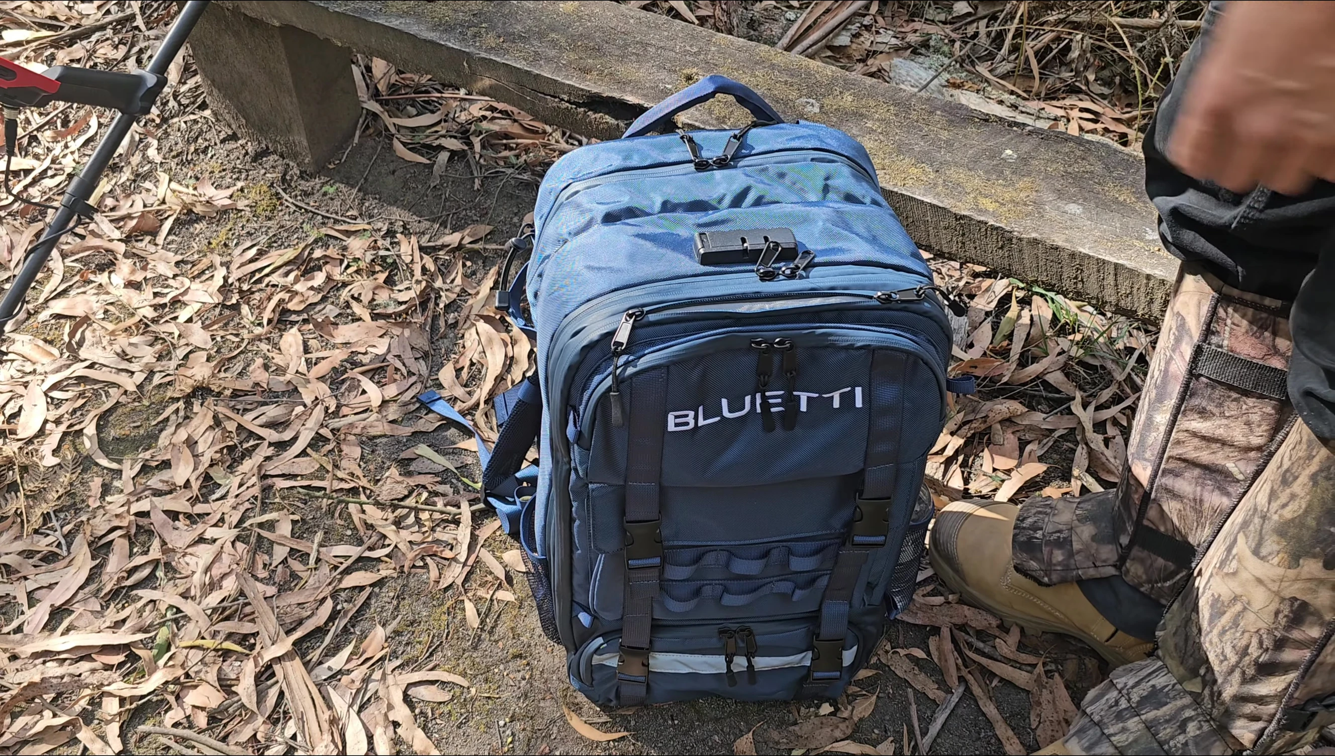 Demonstration of how to access the power ports when the battery is inside the backpack.