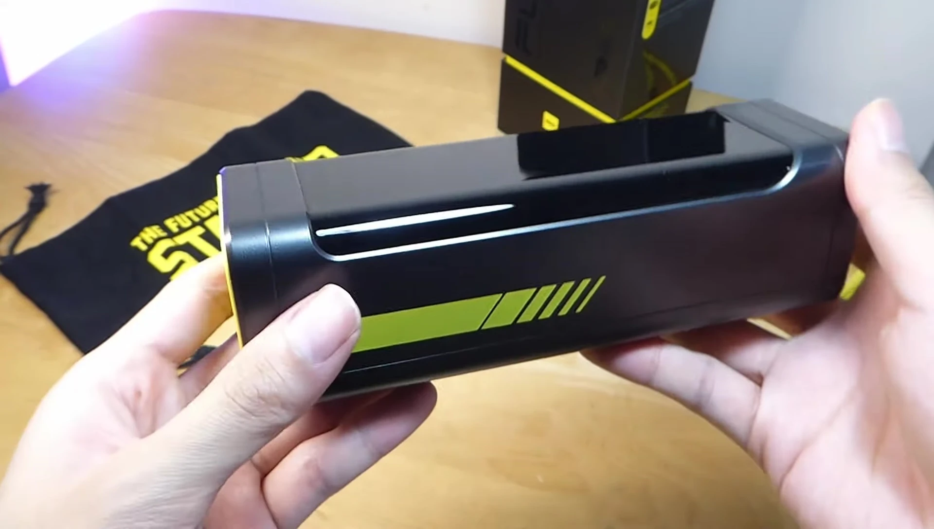 Close-up of the AOHI Starship 240W Power Bank, showing the polycarbonate plastic and mirror-like finish