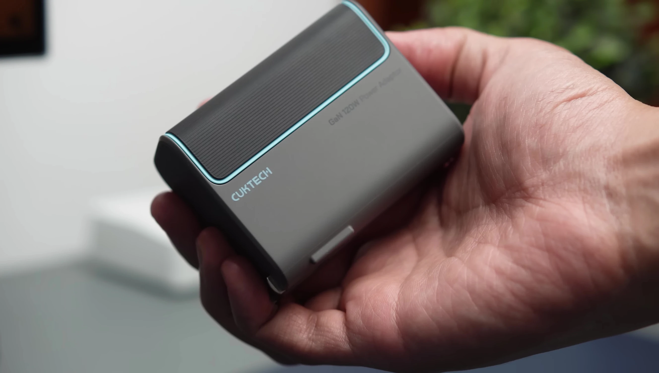 The CUKTECH 120W charger demonstrating its compact design.