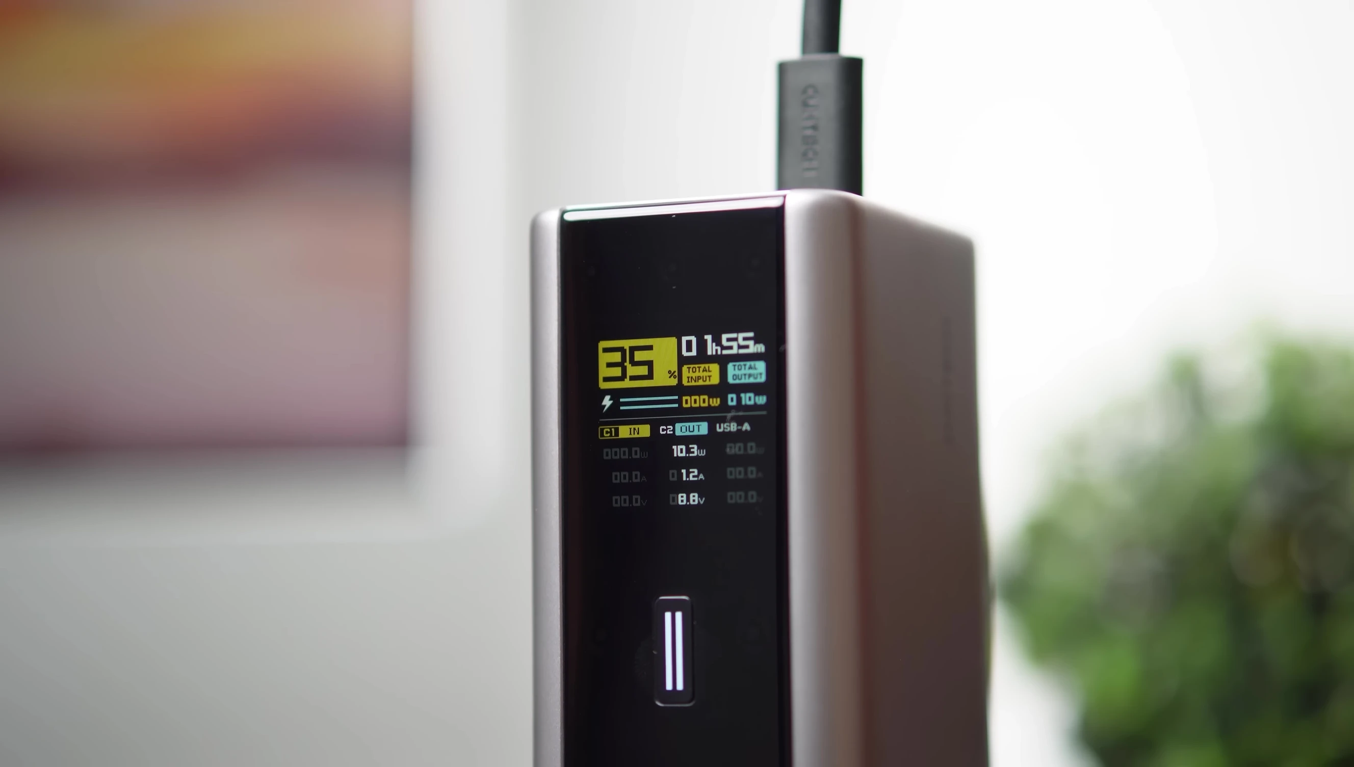 The power bank display showing real-time charging information.