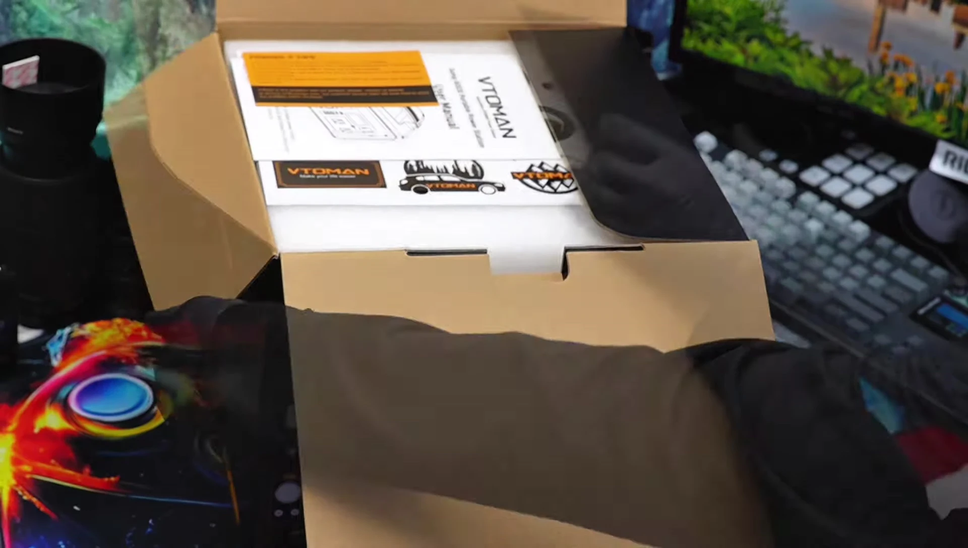 Close-up shot of the included accessories: AC adapter, cables, and manual.