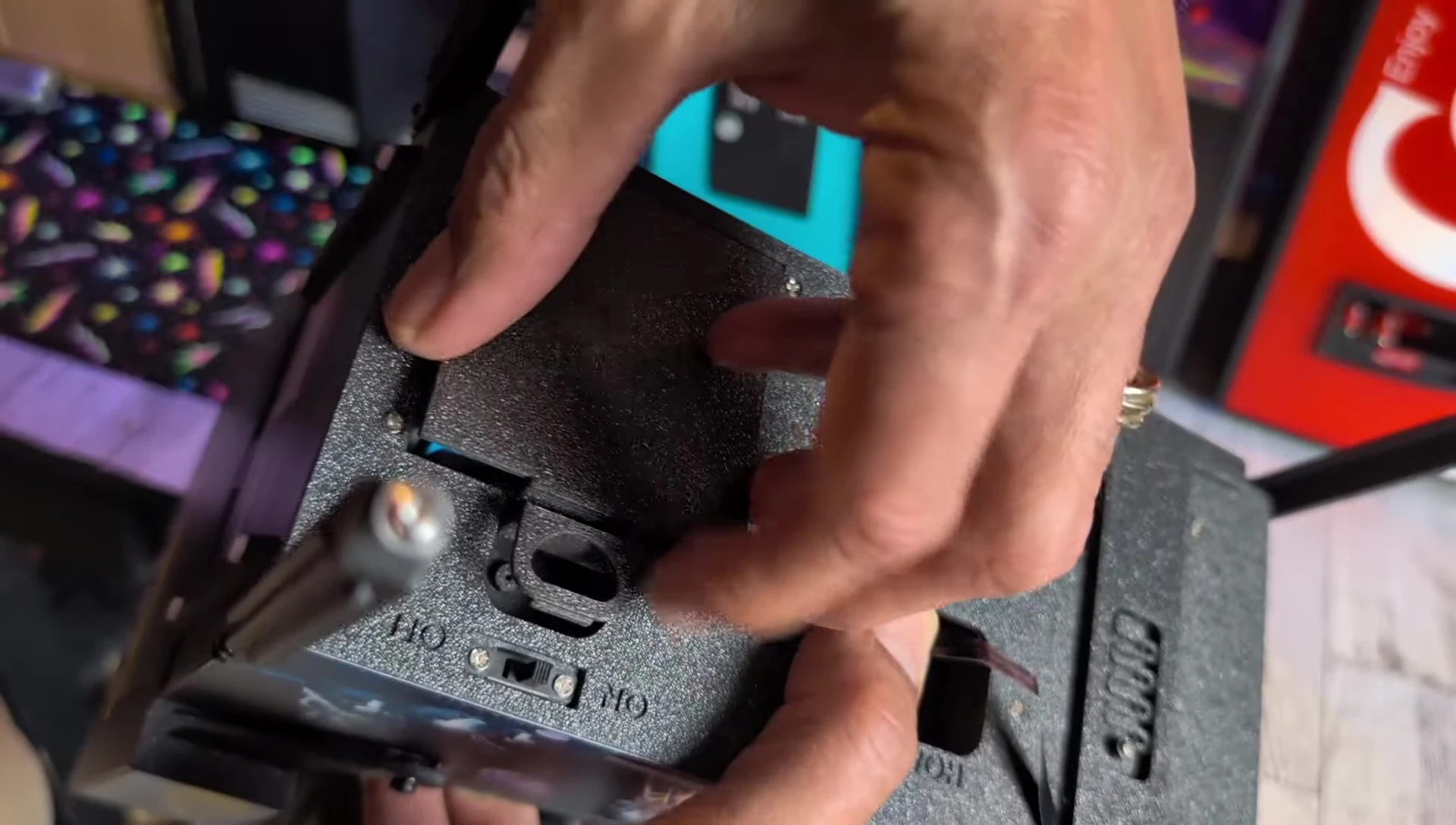 The adapter plugged into a wall outlet, powering the pinball machine.