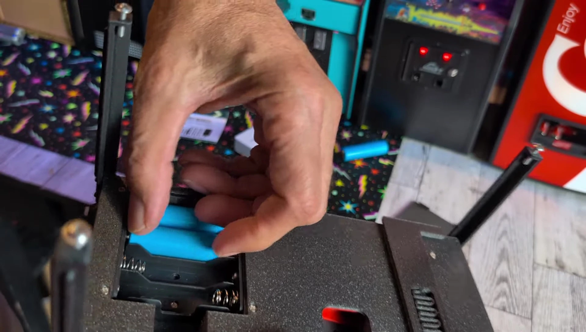 Inserting the dummy batteries and connecting the power cable.