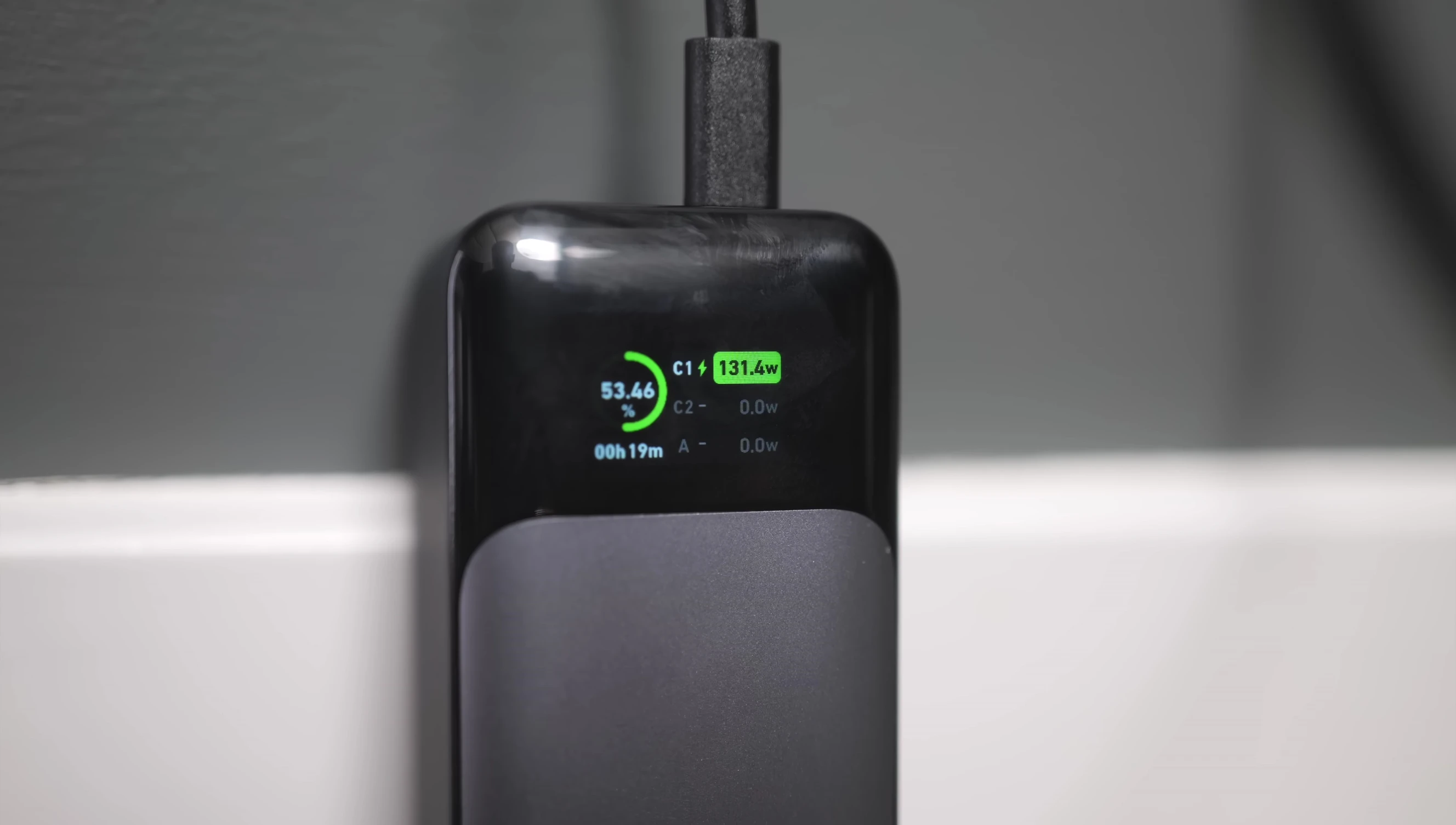 Close-up of the Anker 737's display screen showing power levels and charging information.