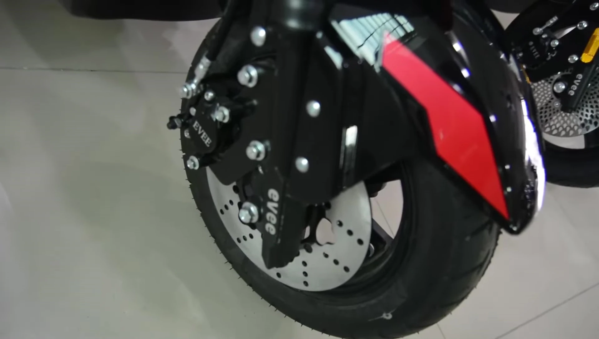 Close-up shot of the electric bike's tires and brakes.