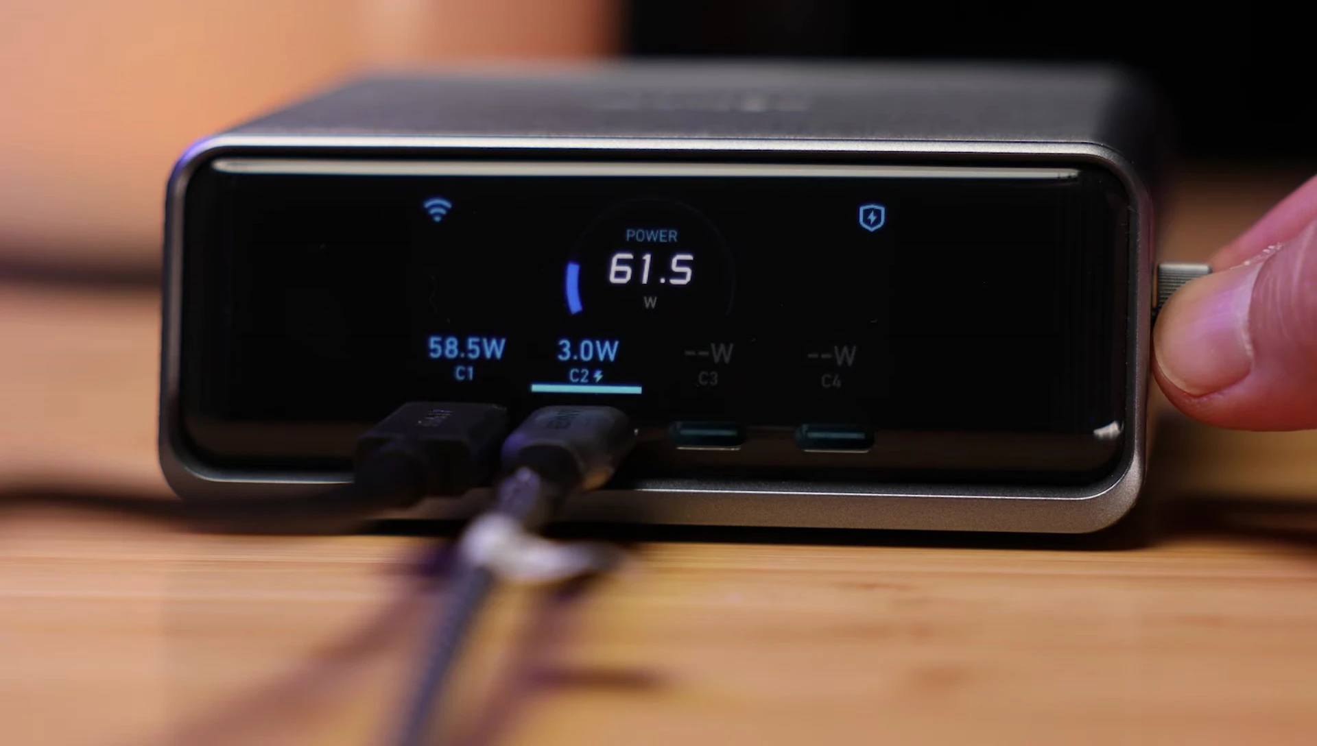 Close-up shot of the display showing detailed charging statistics and power curves for each port.