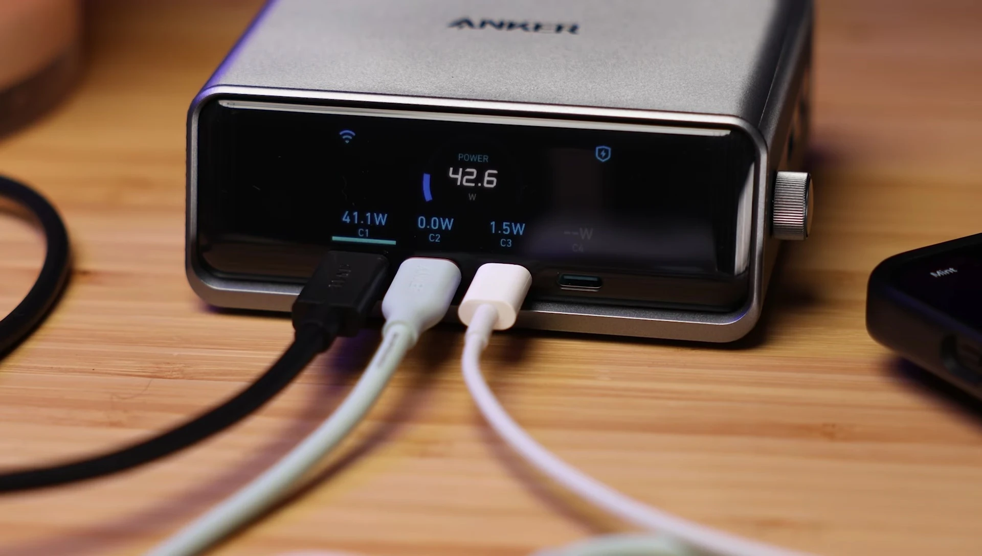 Image of the Anker Prime charger showcasing the digital interface and the rotary dial for power control.