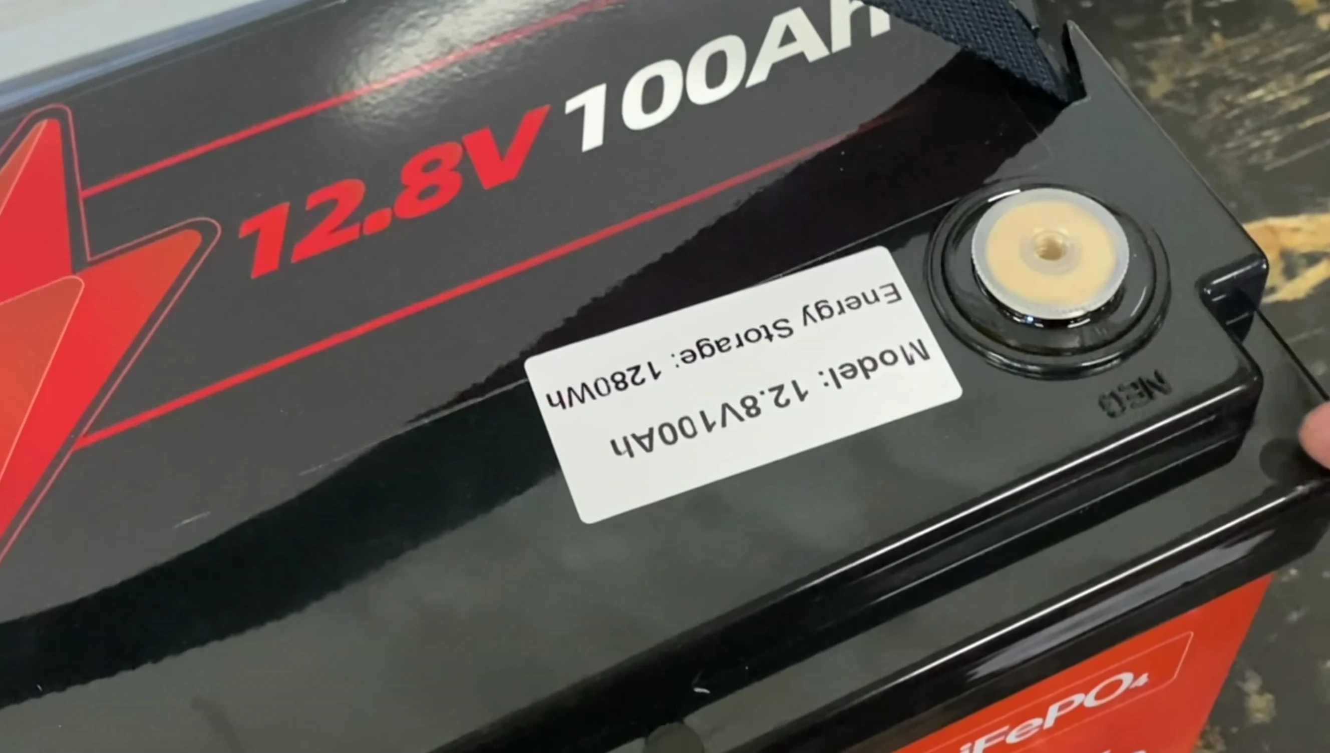 Opening the battery enclosure to reveal the internal components.