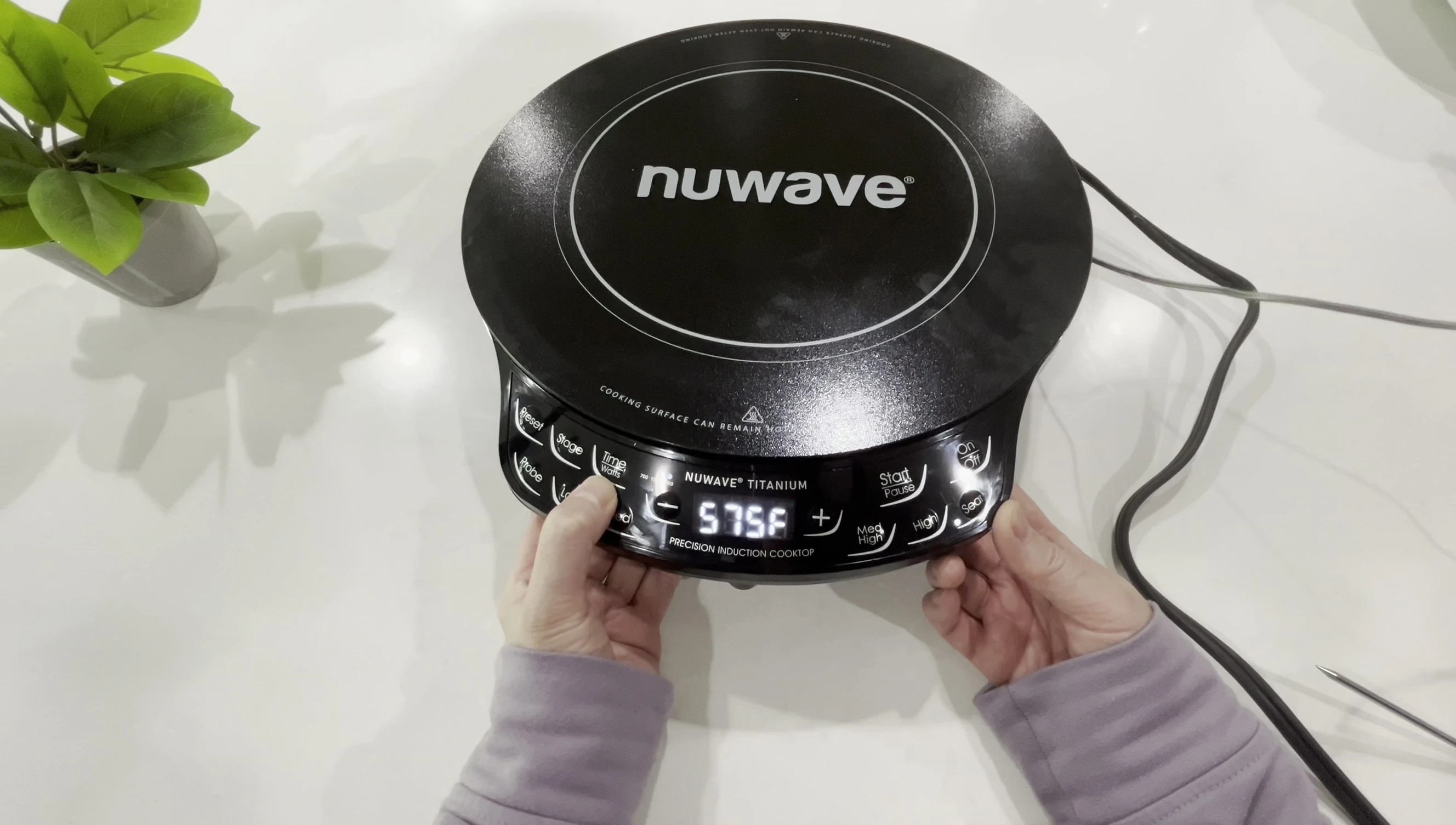 Close-up on the shared timer/wattage button