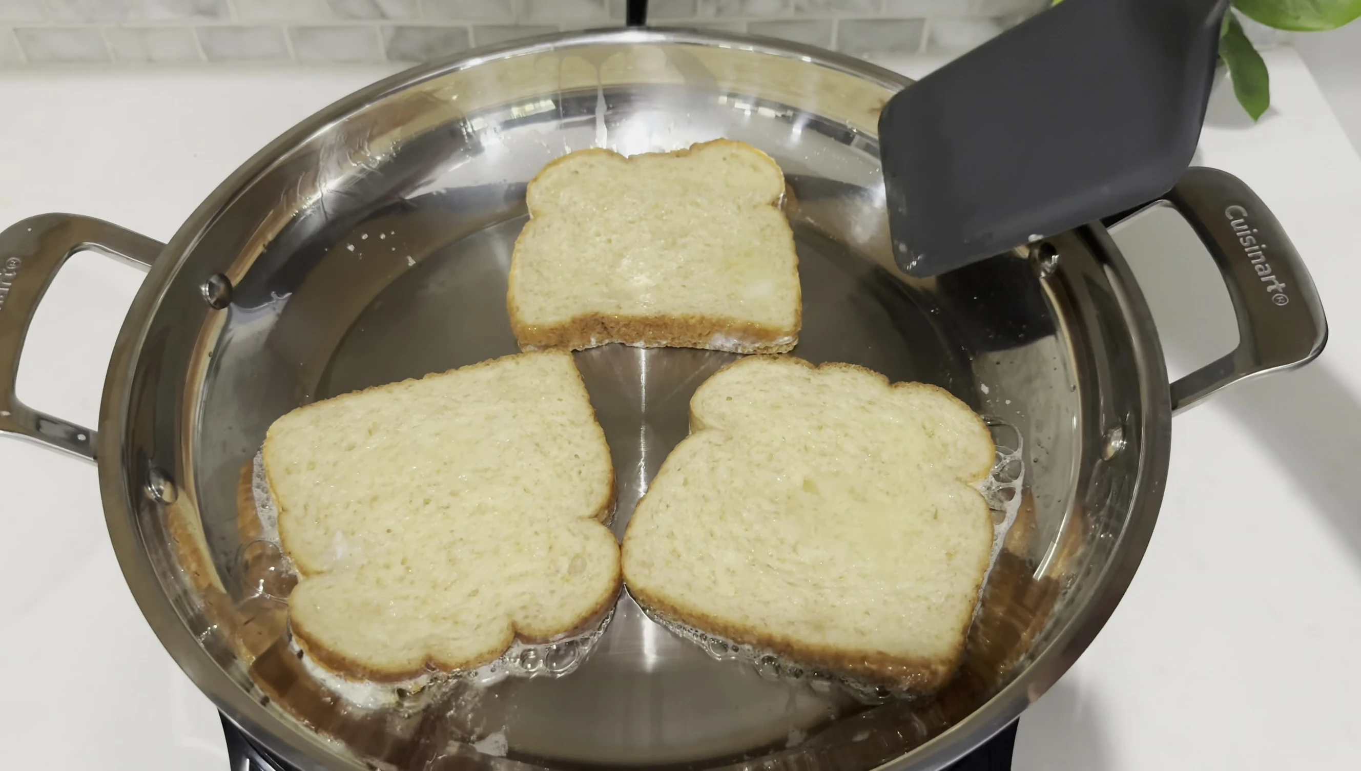 French toast cooking in a 12-inch pan on the cooktop