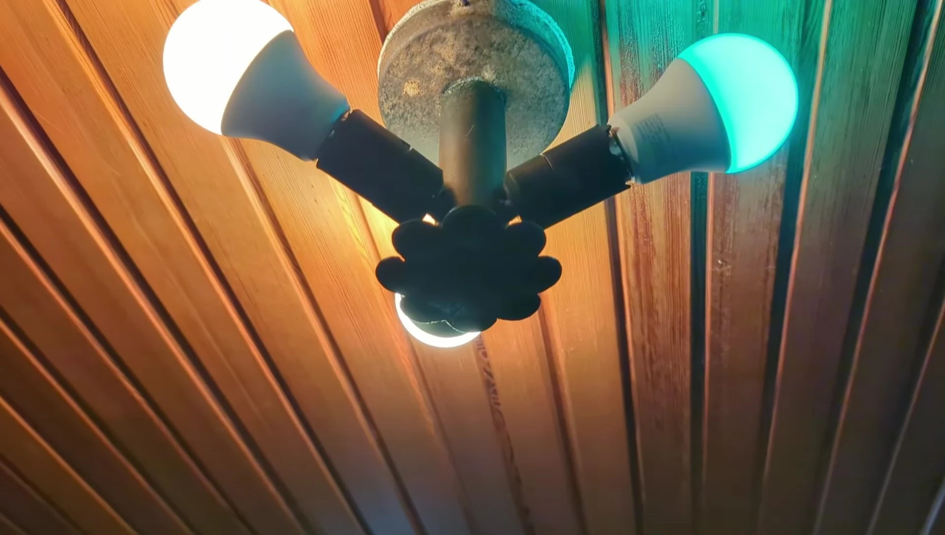 Close-up of the E27 bulb being screwed into a lamp socket.