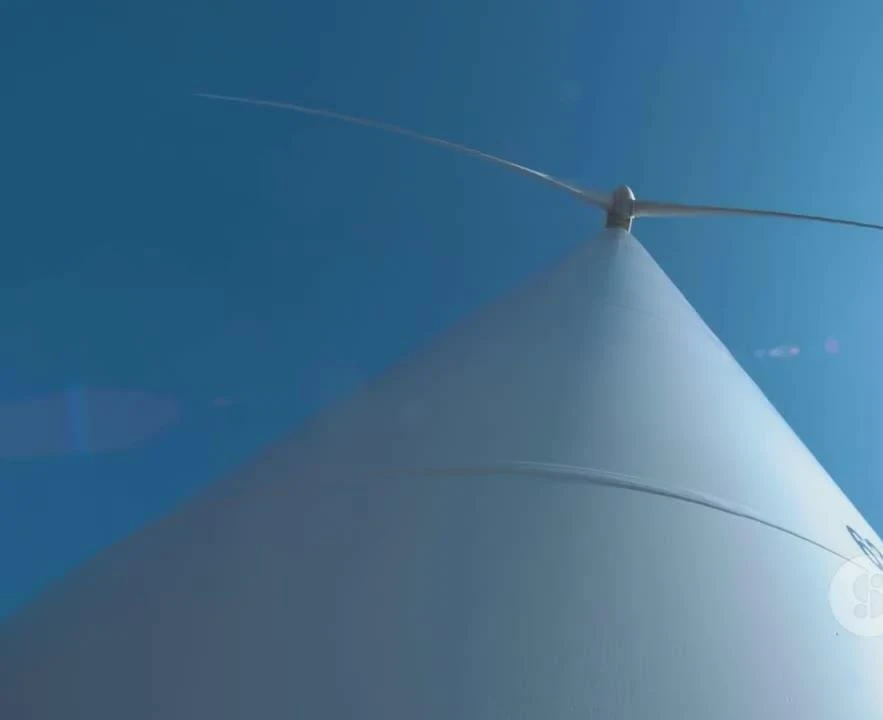 Large wind turbines in a field.