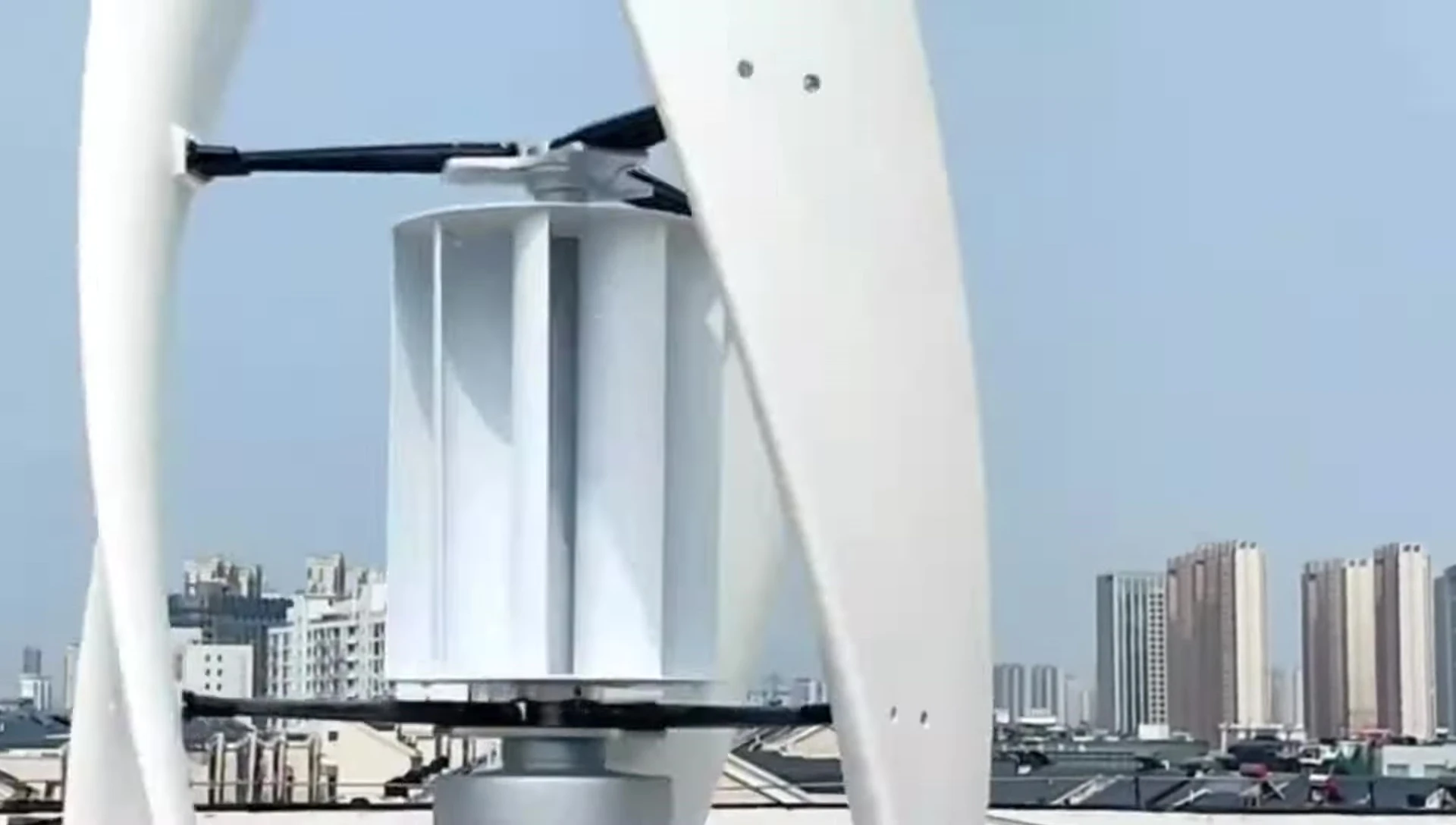 Image highlighting a vertical wind turbine operating in stormy weather.