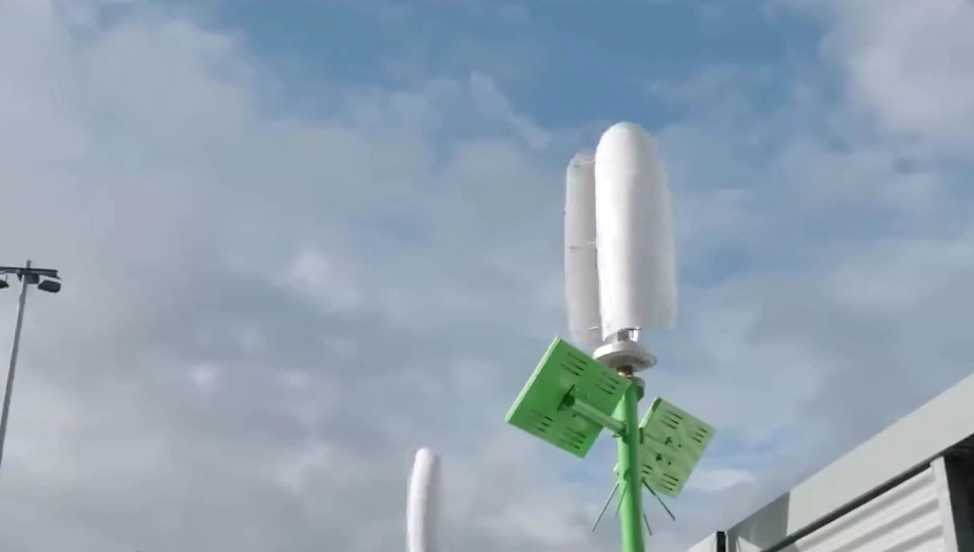 Image showing a compact vertical wind turbine installed on a roof.