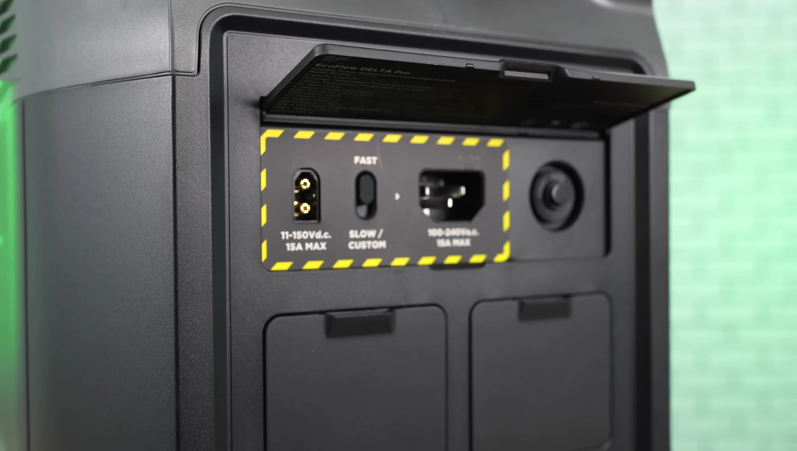 The speaker showing the various charging ports and cables included with the unit