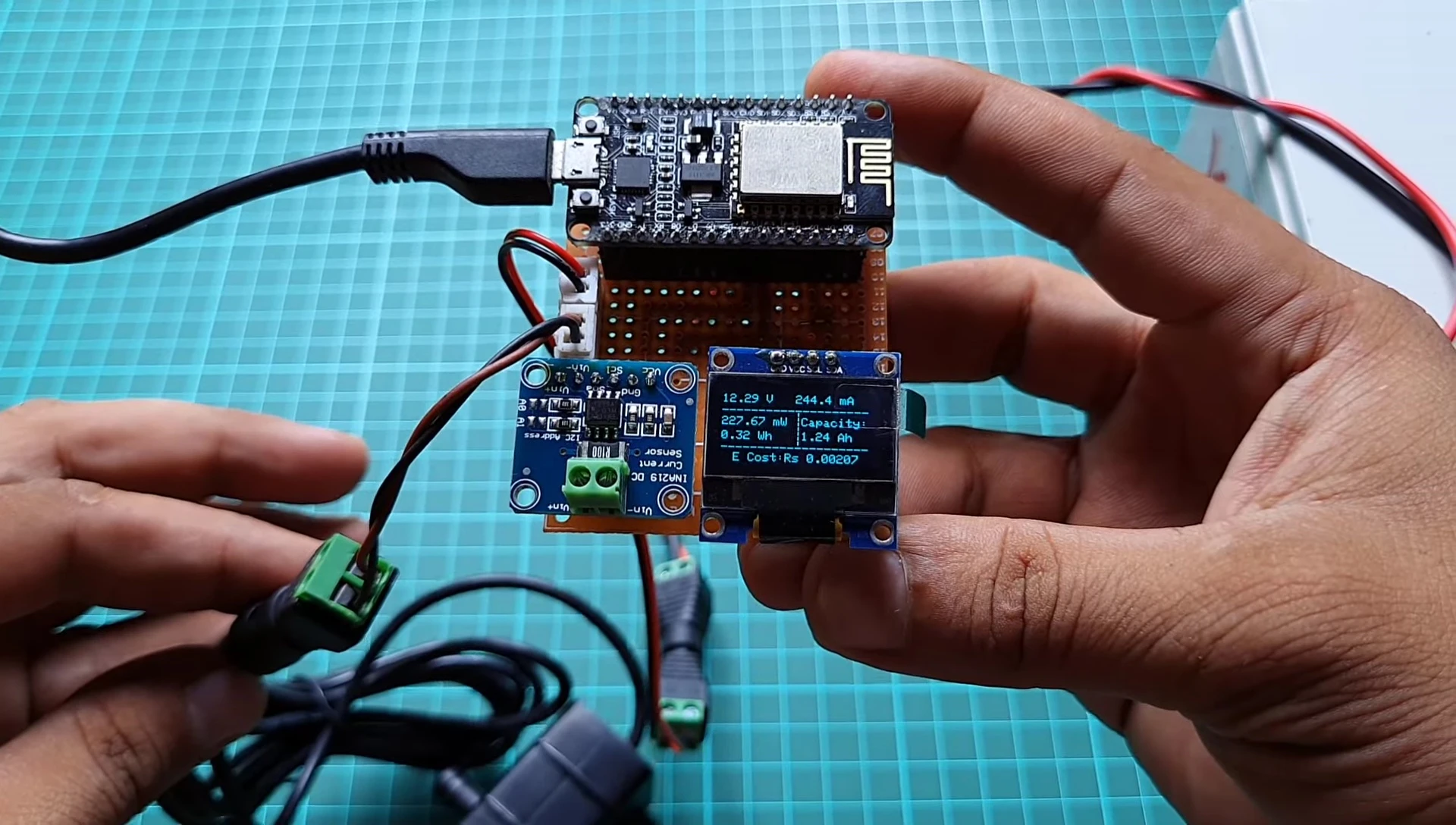 The OLED display showing real-time readings