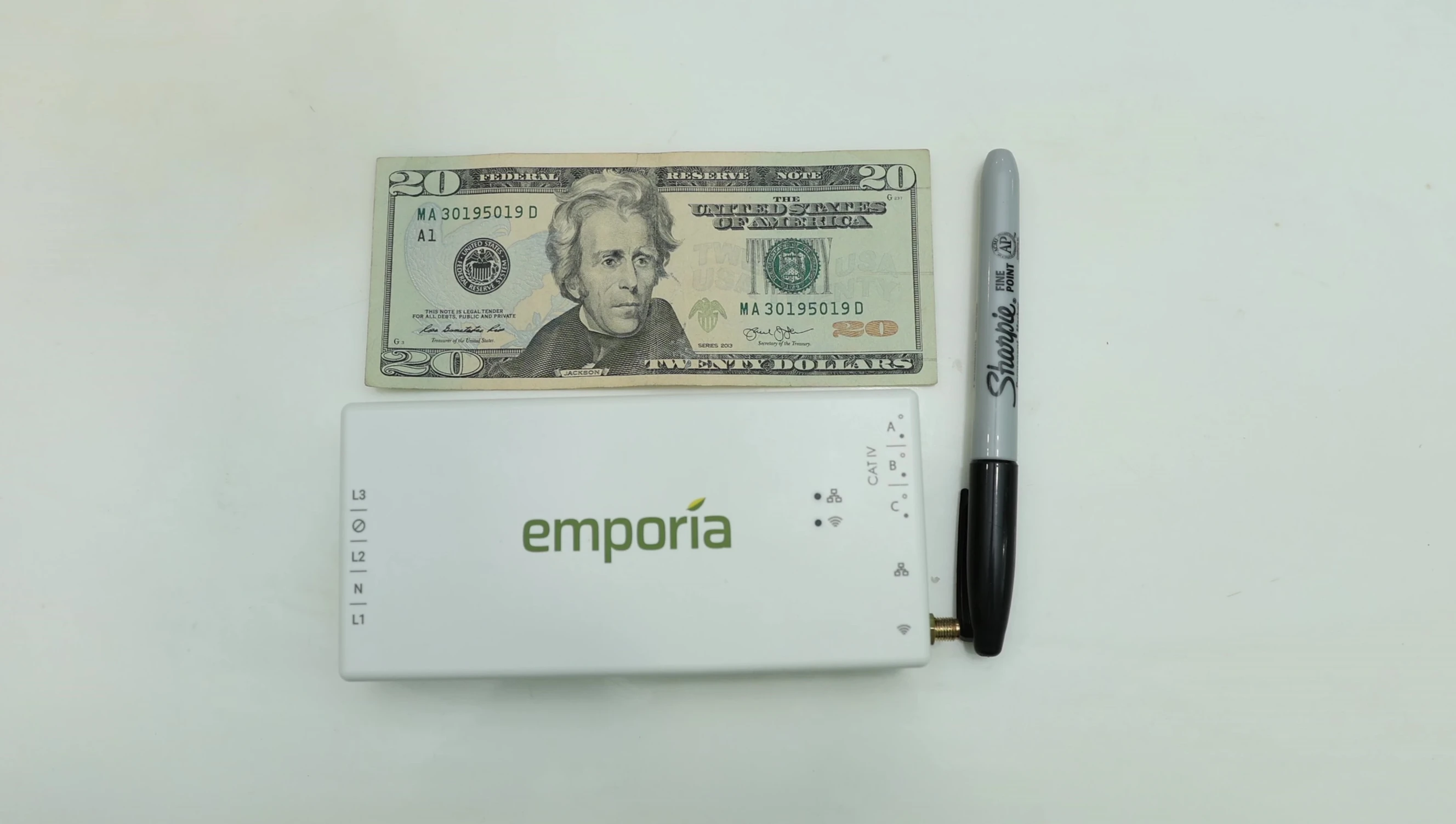 Close-up of the Emporia Vue Gen 3 unit, highlighting its small size compared to a $20 bill.