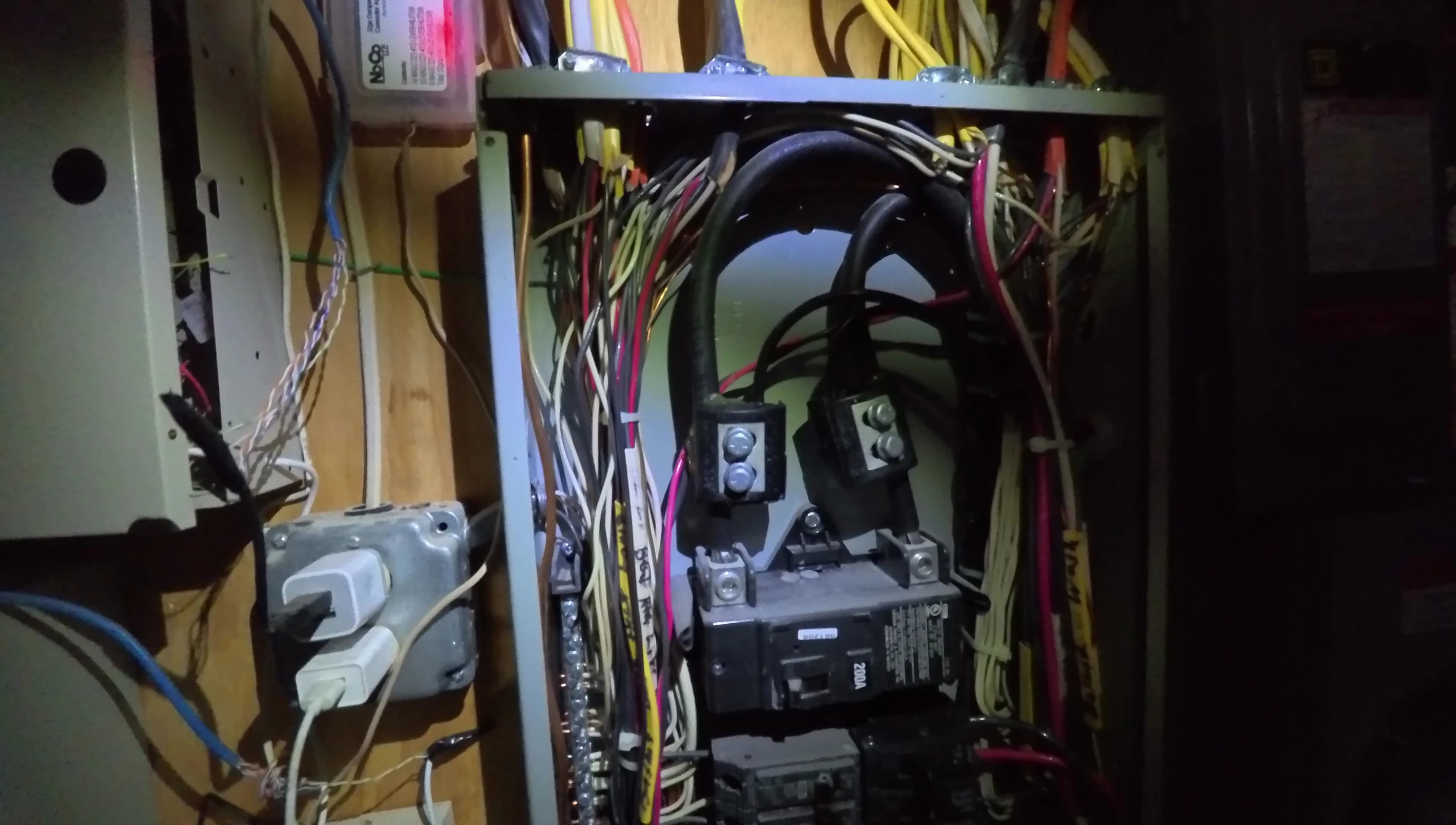 Close-up of the CT clamps being attached to circuit breakers.