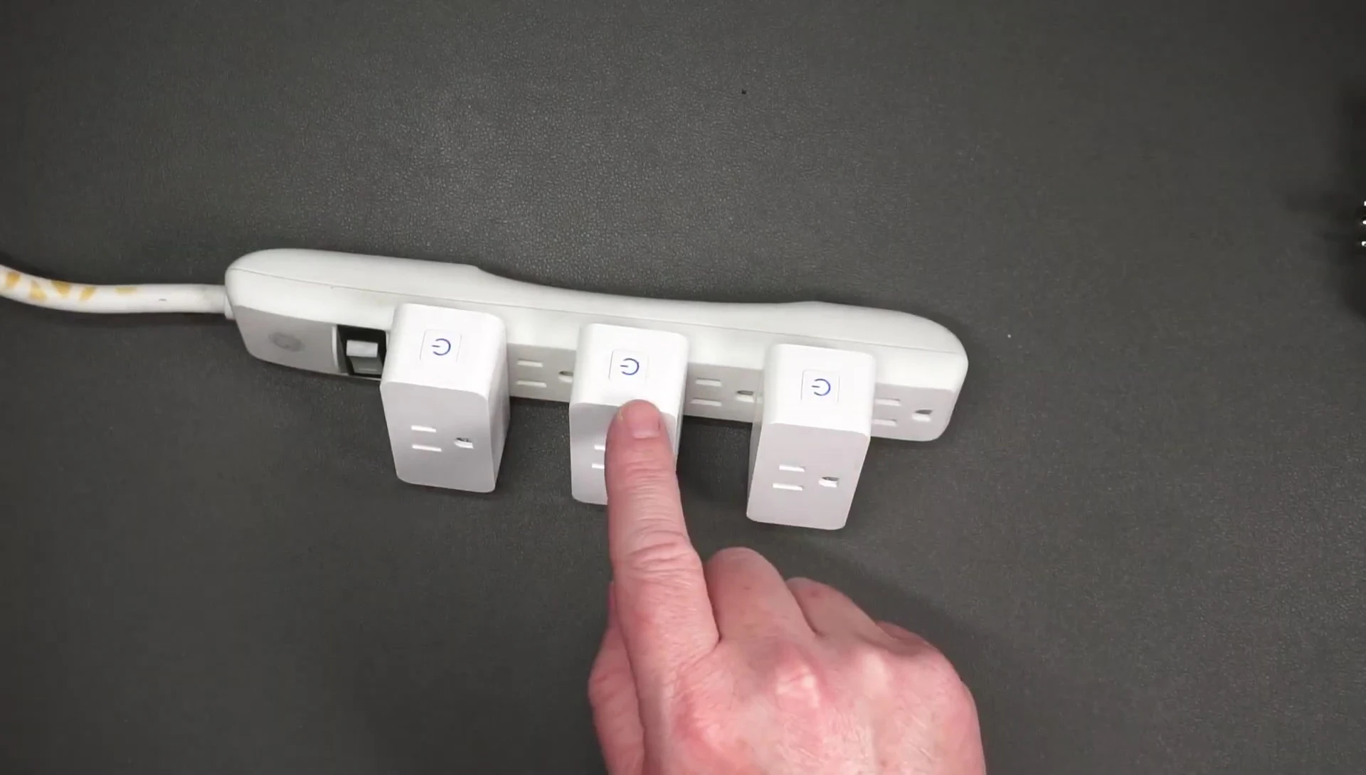 Smart plug with a solid blue LED light indicating it's powered on.