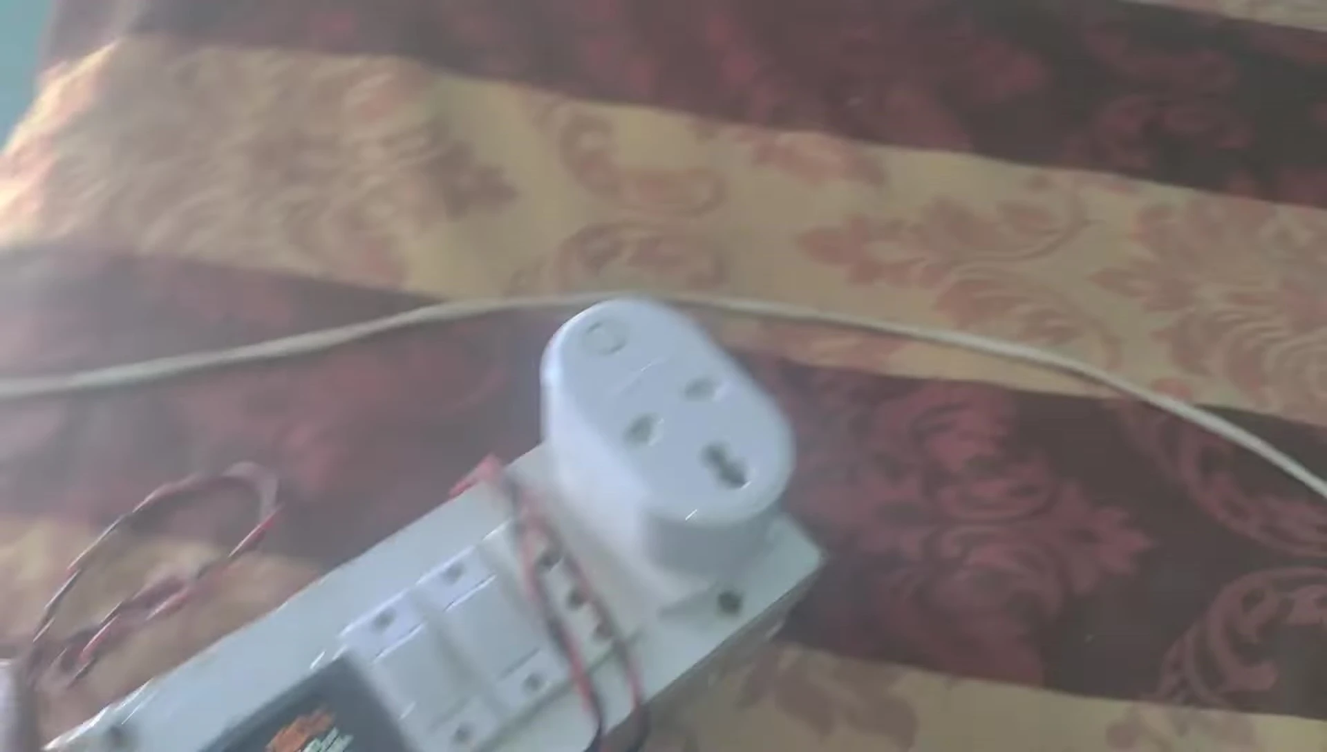 The Halonix smart plug connected to the energy meter during testing.