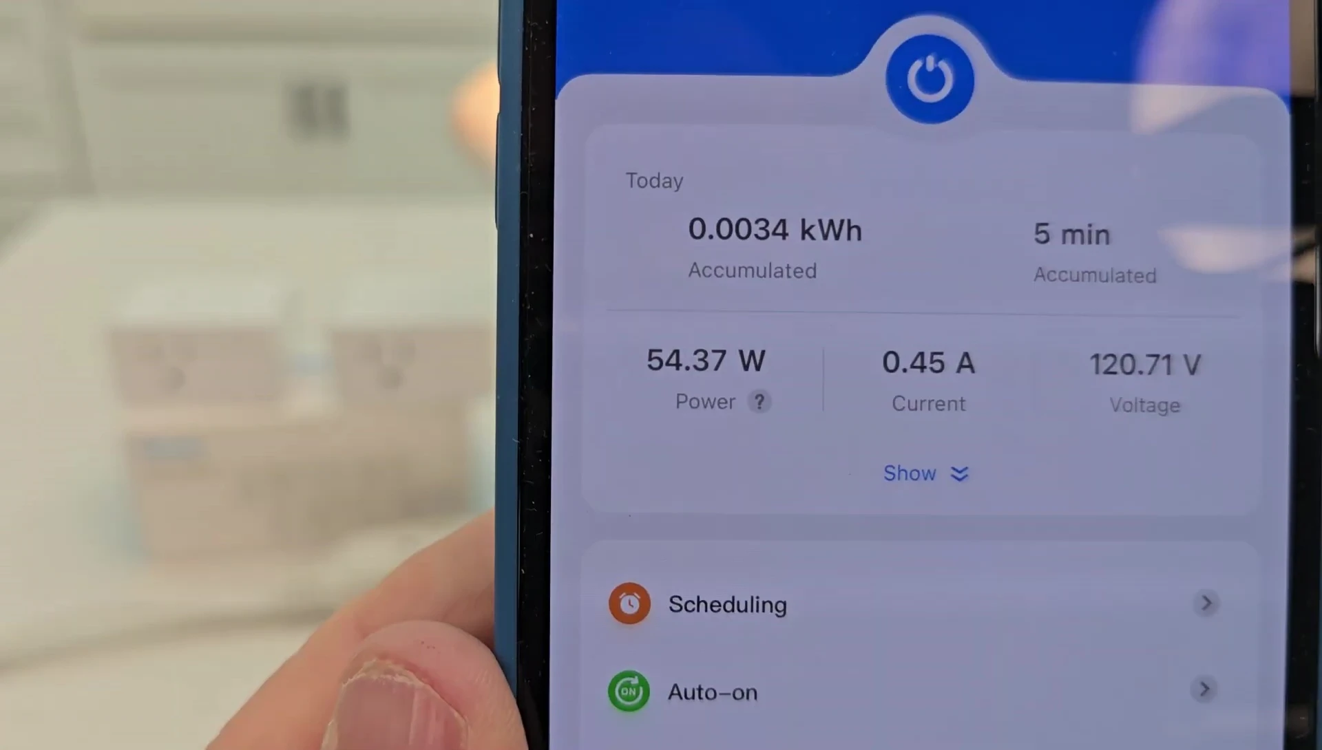 Close-up of the app screen displaying wattage and other energy metrics