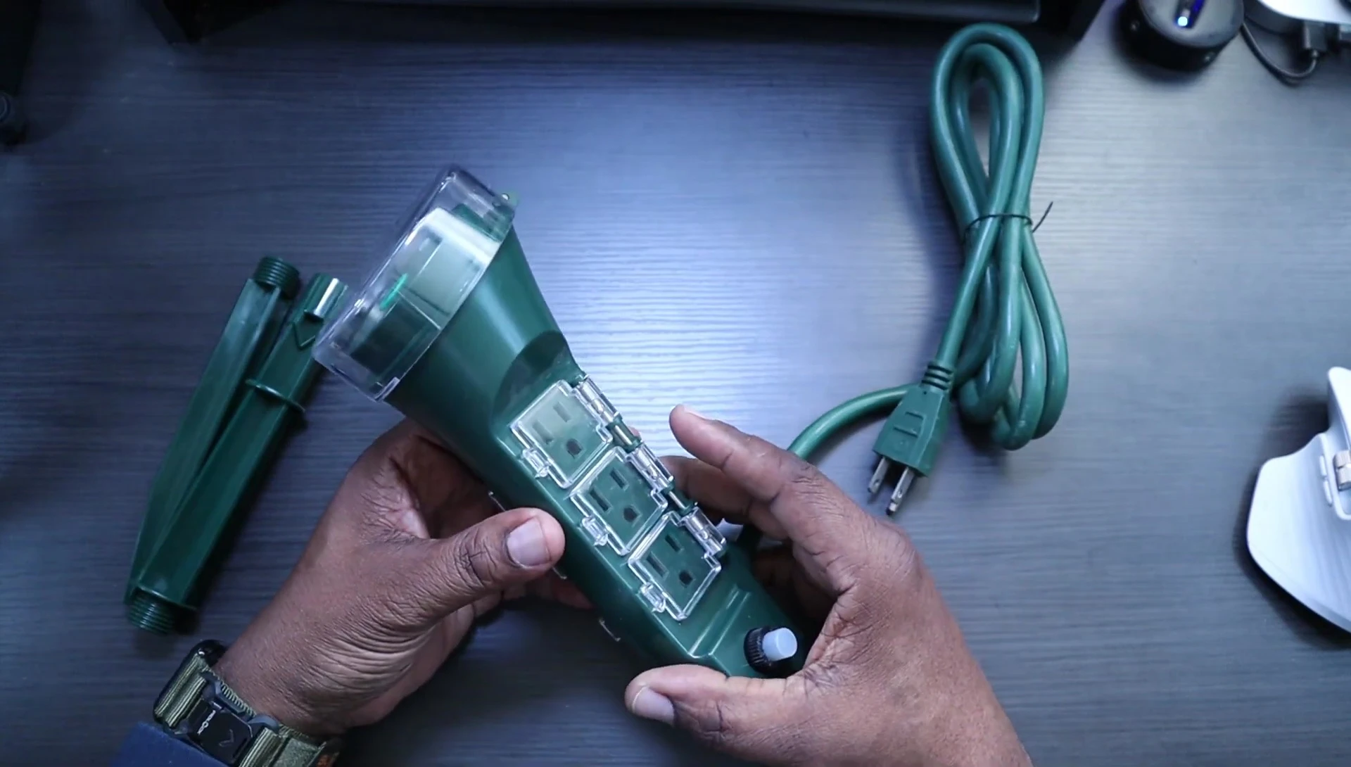 The smart plug itself, showcasing the six outlets and protective covers.