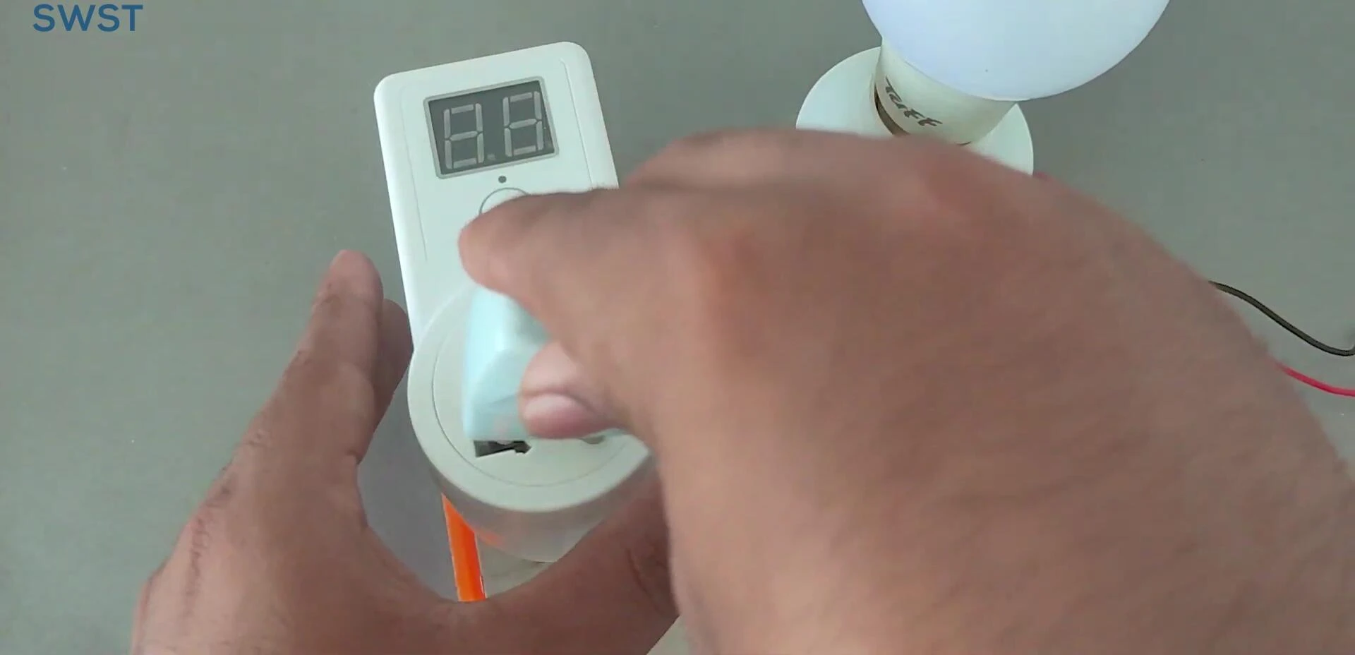 The timer switch connected to a light bulb, demonstrating the setup.