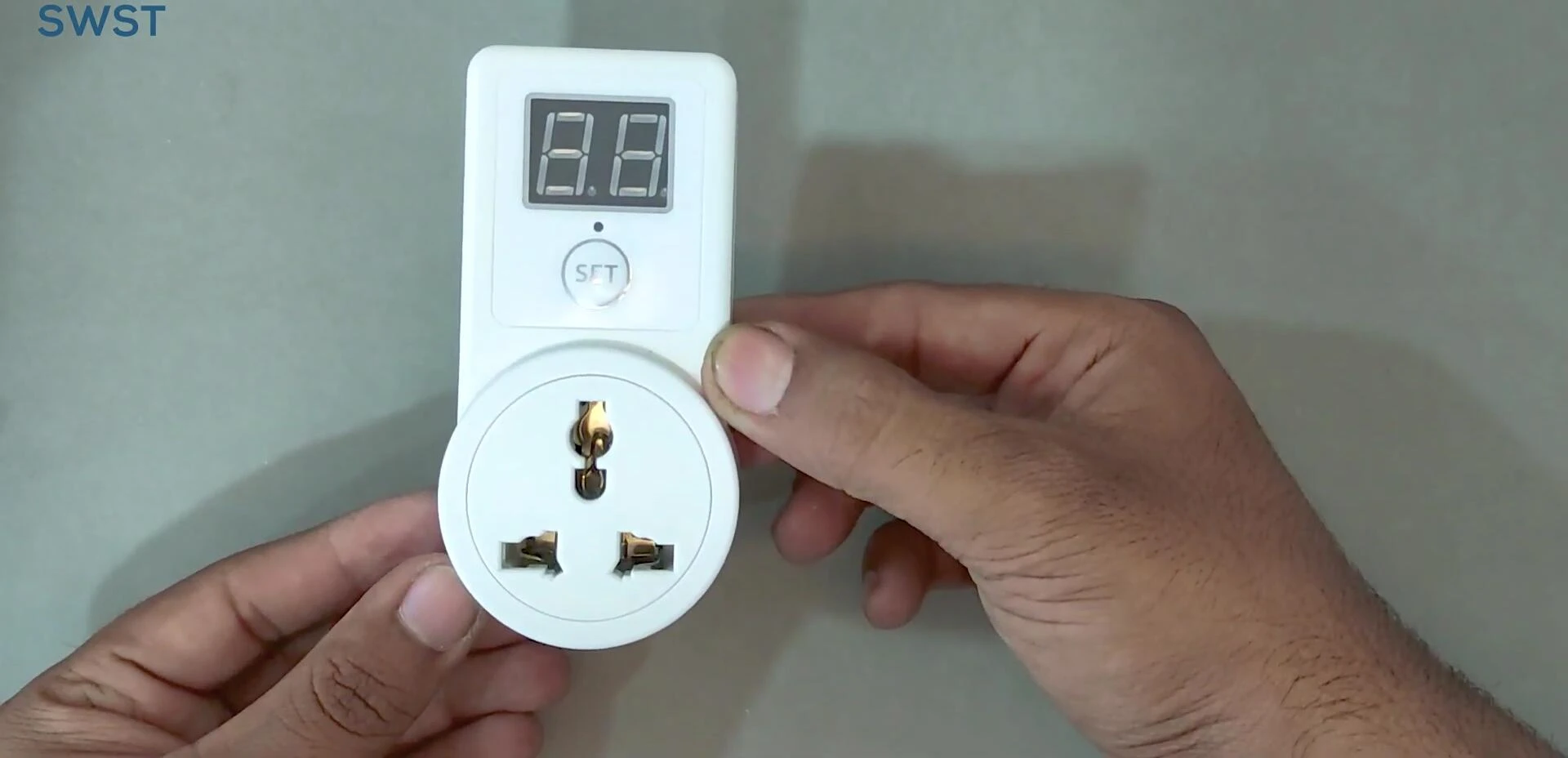 Close-up of the timer switch showing its small screen and buttons.